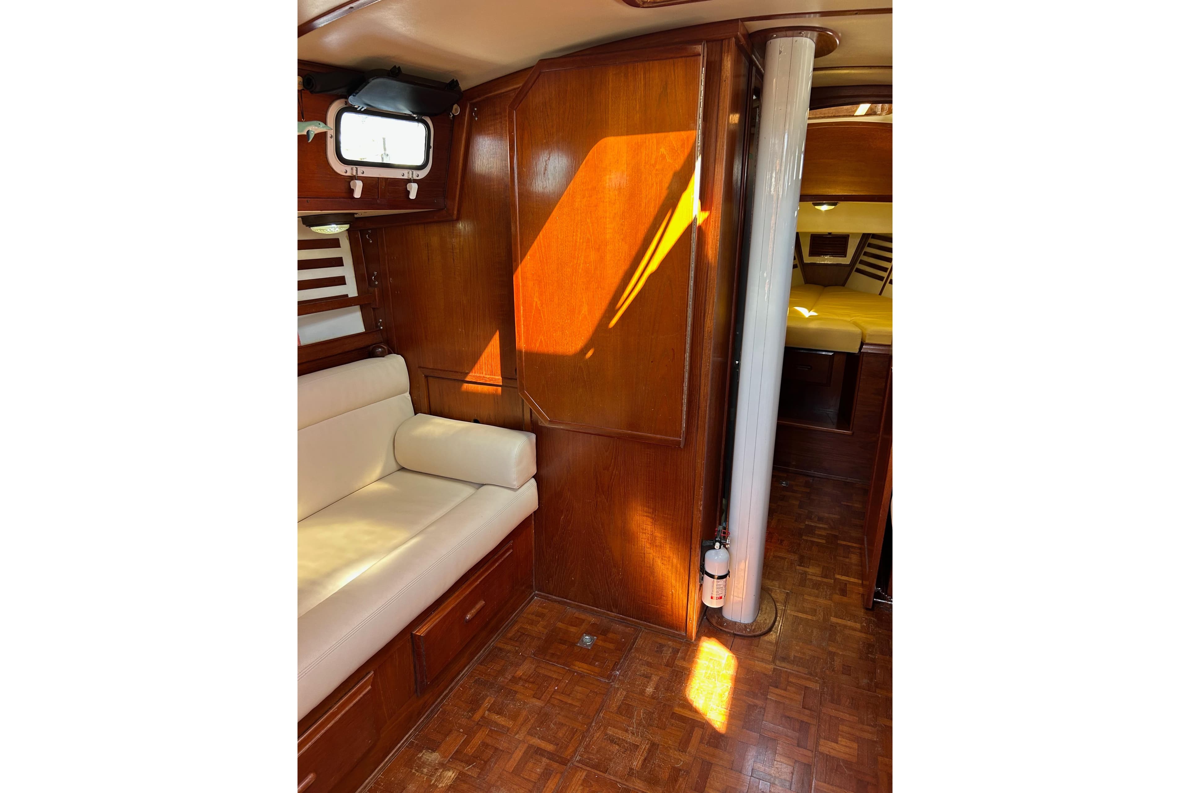 Interior of 1982 Endeavour 37 sailboat with wood paneling and cushioned seating.