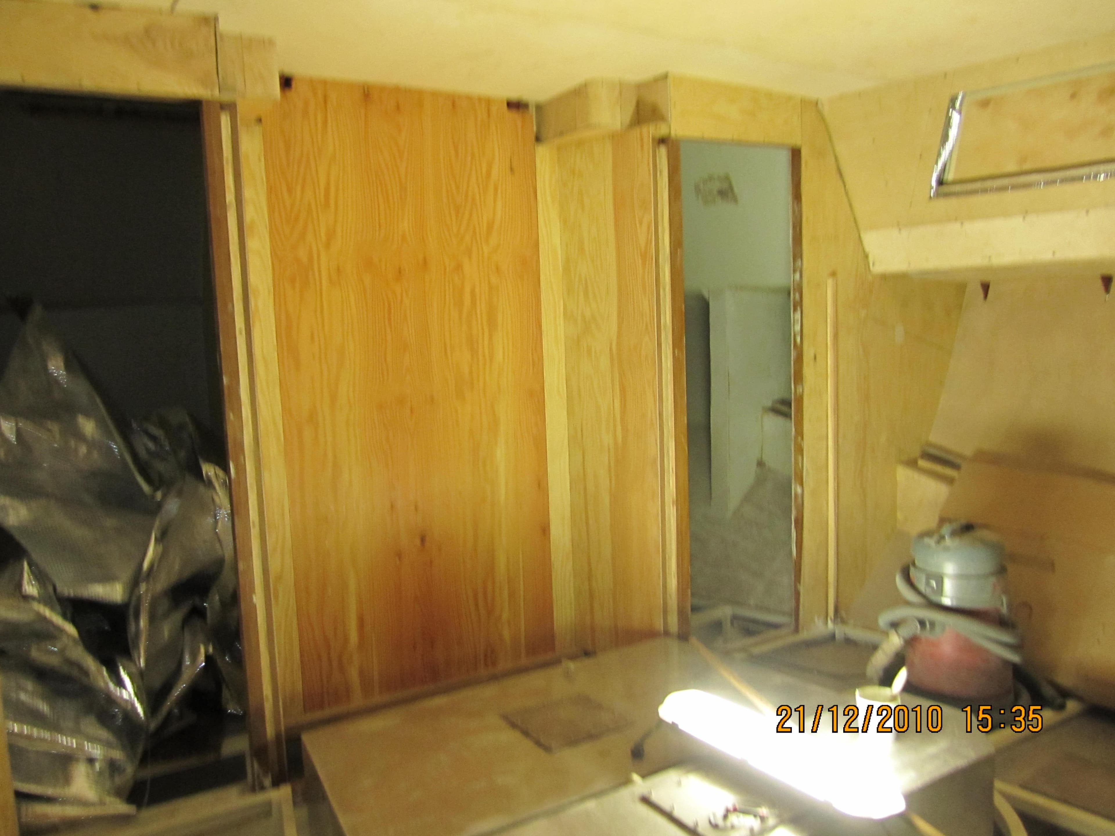 Wood-paneled interior under construction with tools, Custom Line SM Europe SMY84, 2022.