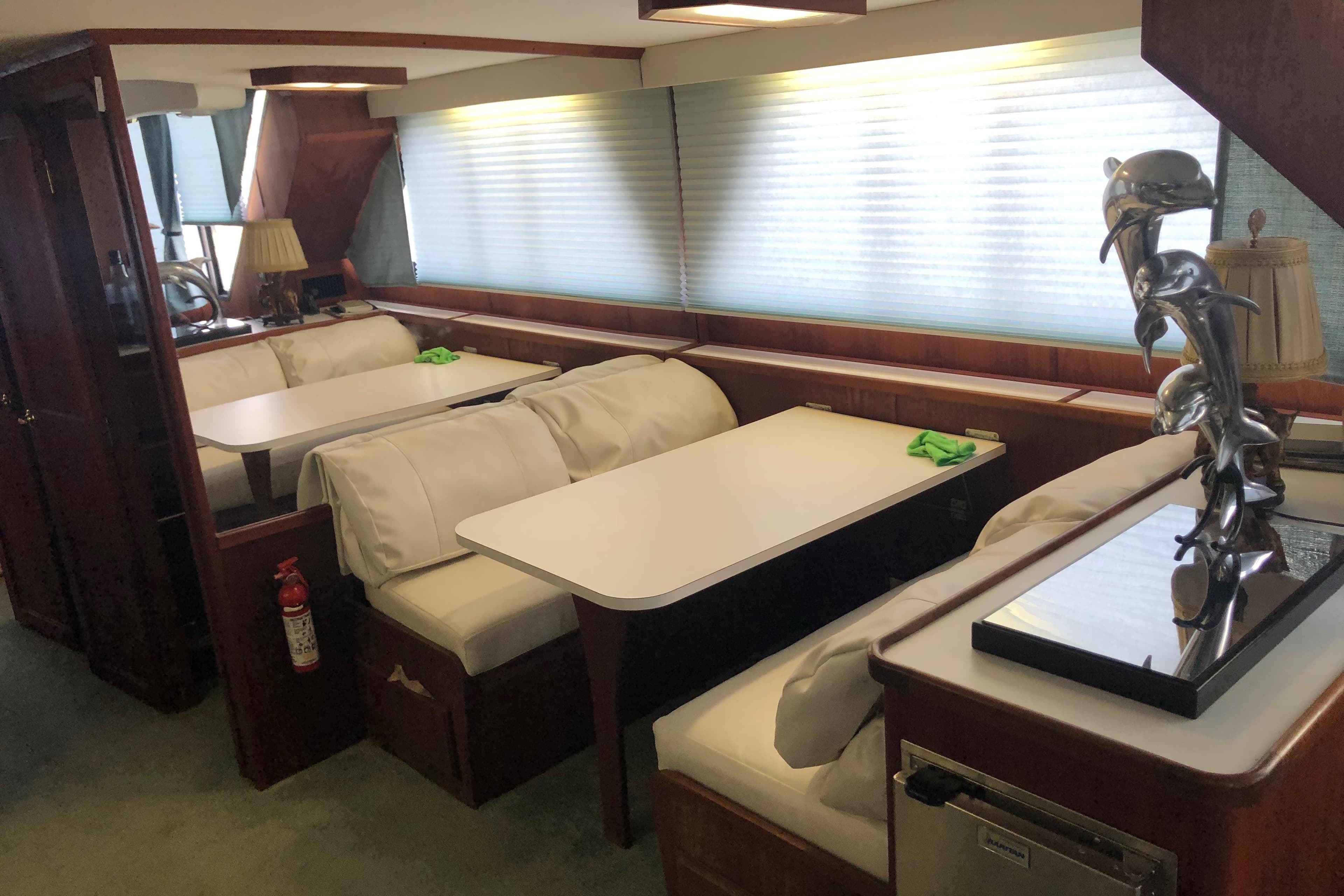 Interior of 1989 Bluewater Yachts 55' Coastal Cruiser with dining area and dolphin sculpture.