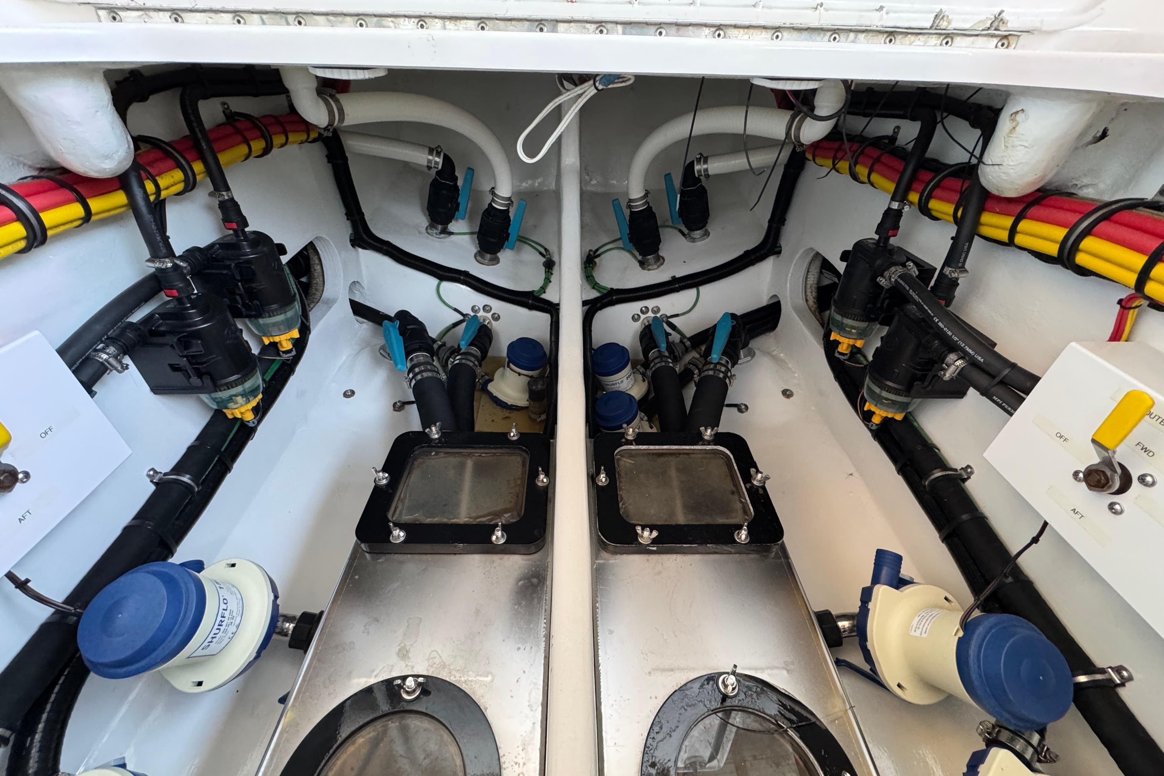 Engine compartment of a 2022 Nor-Tech 392 Super Fish, showcasing detailed wiring and components.