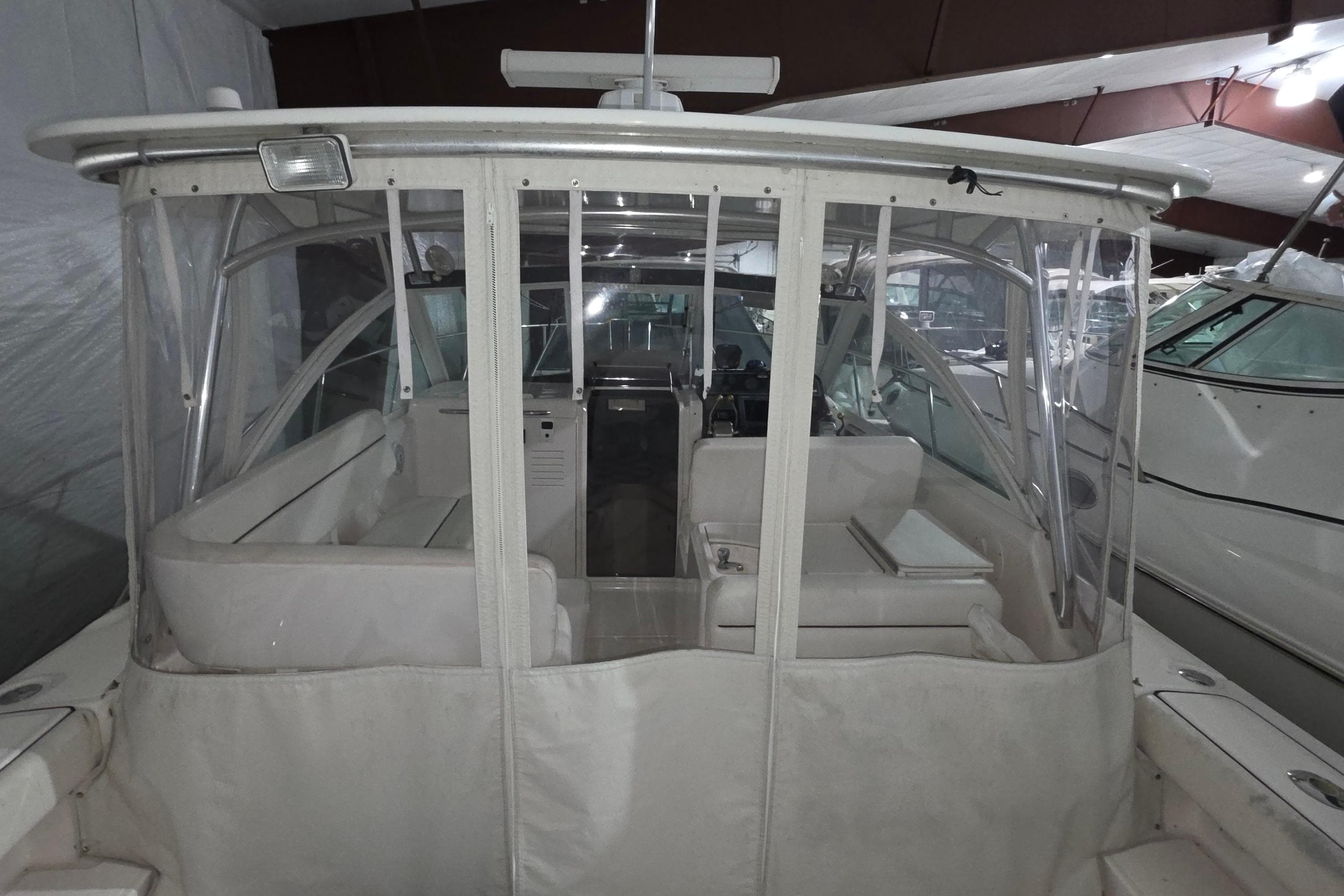2005 Tiara 290 Coronet boat interior with clear enclosure in a storage facility.