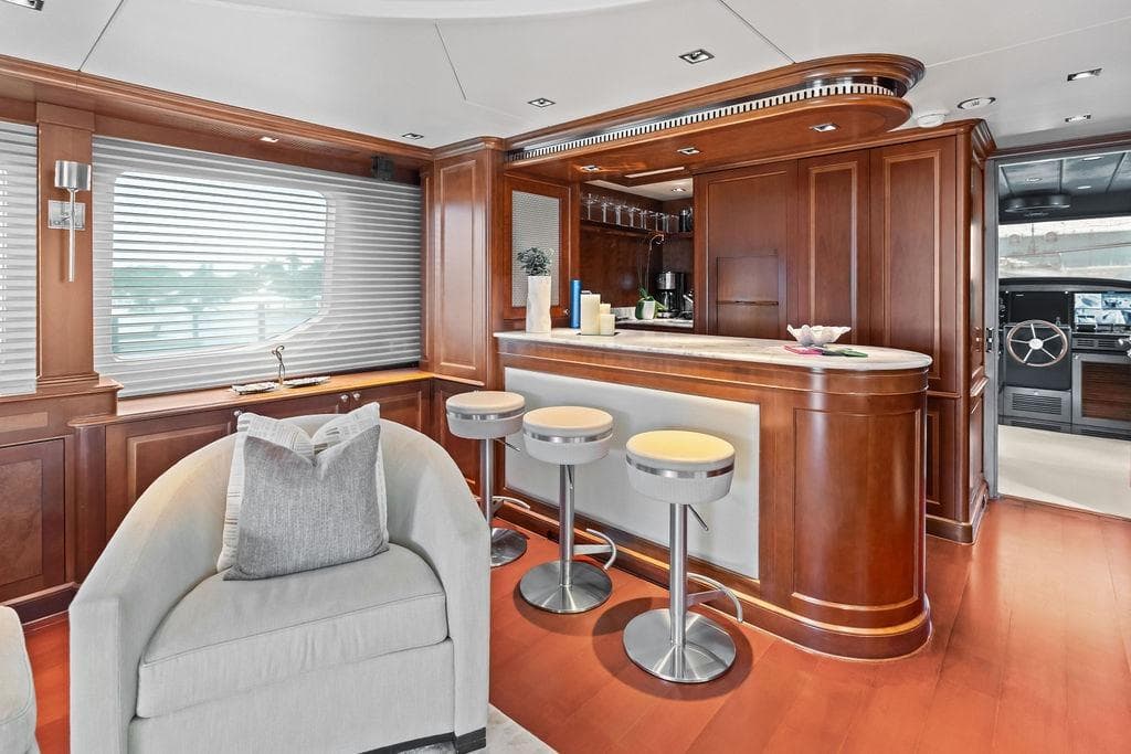 Luxurious 2008 Benetti Classic yacht interior with elegant wood paneling and modern bar area.