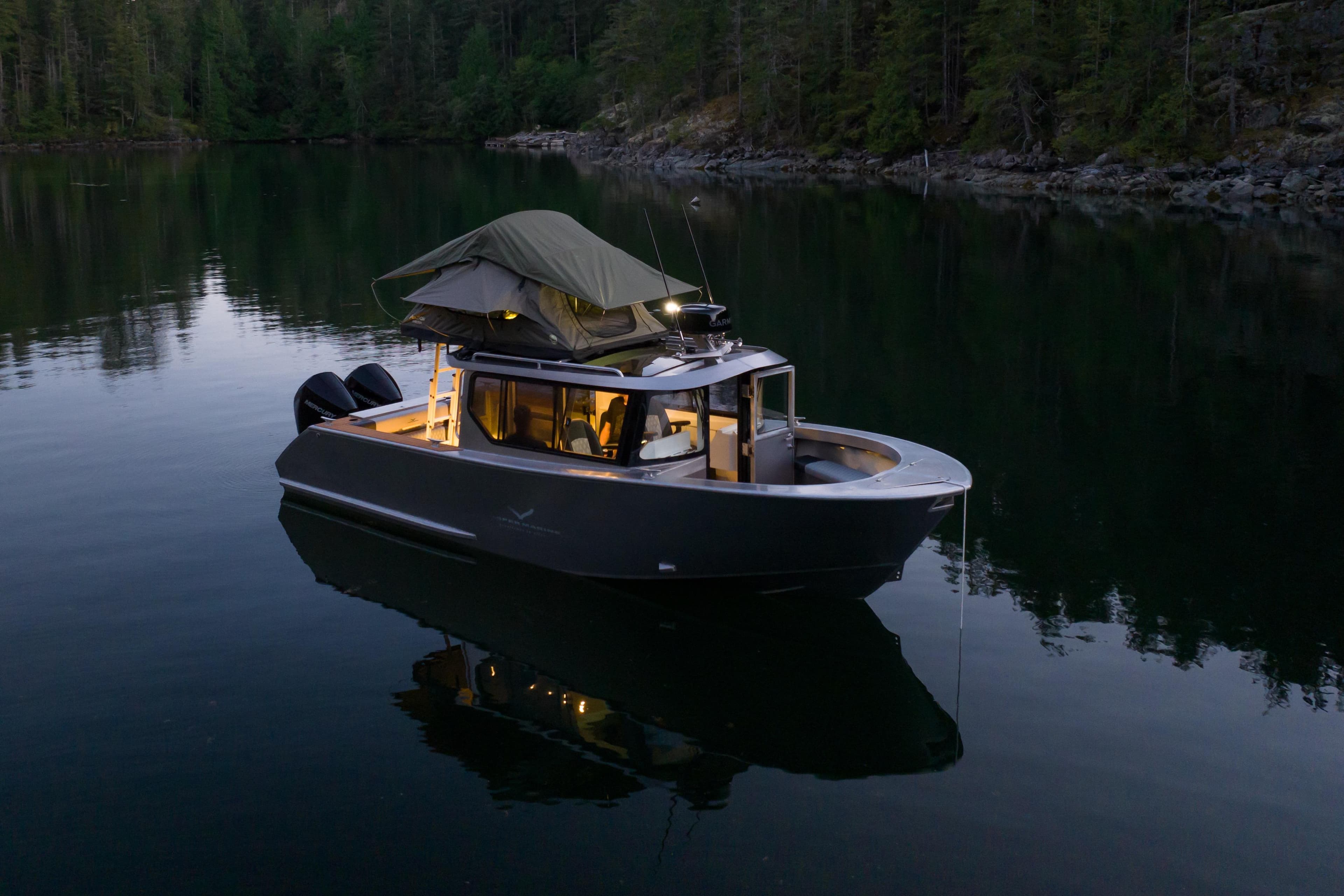 2026 Jasper Marine Defender 22 boat with rooftop tent on serene lake.
