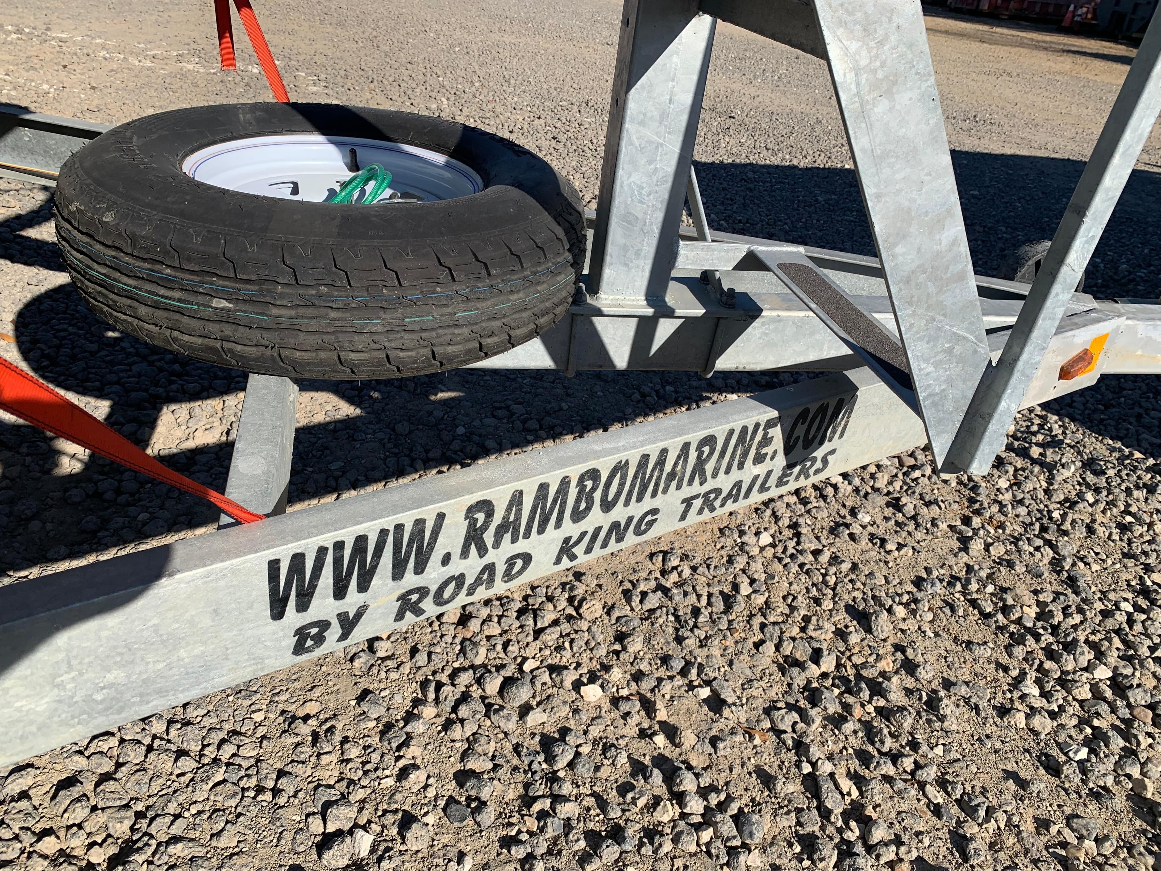 Boat trailer by Road King Trailers, featuring spare tire, gravel ground, Marker One ML4, 2017.