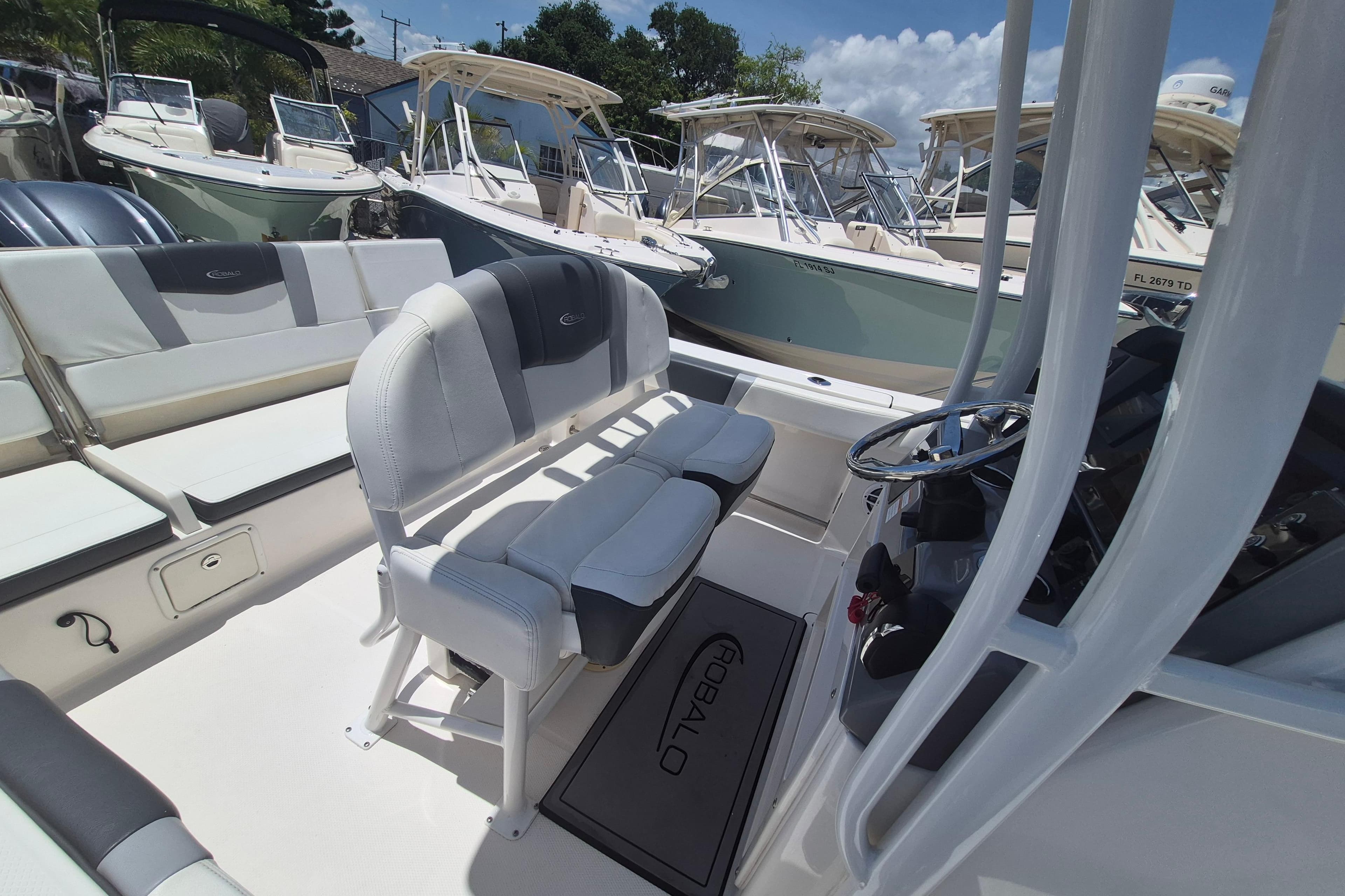 2023 Robalo R230 Center Console boat interior with seating and steering wheel.