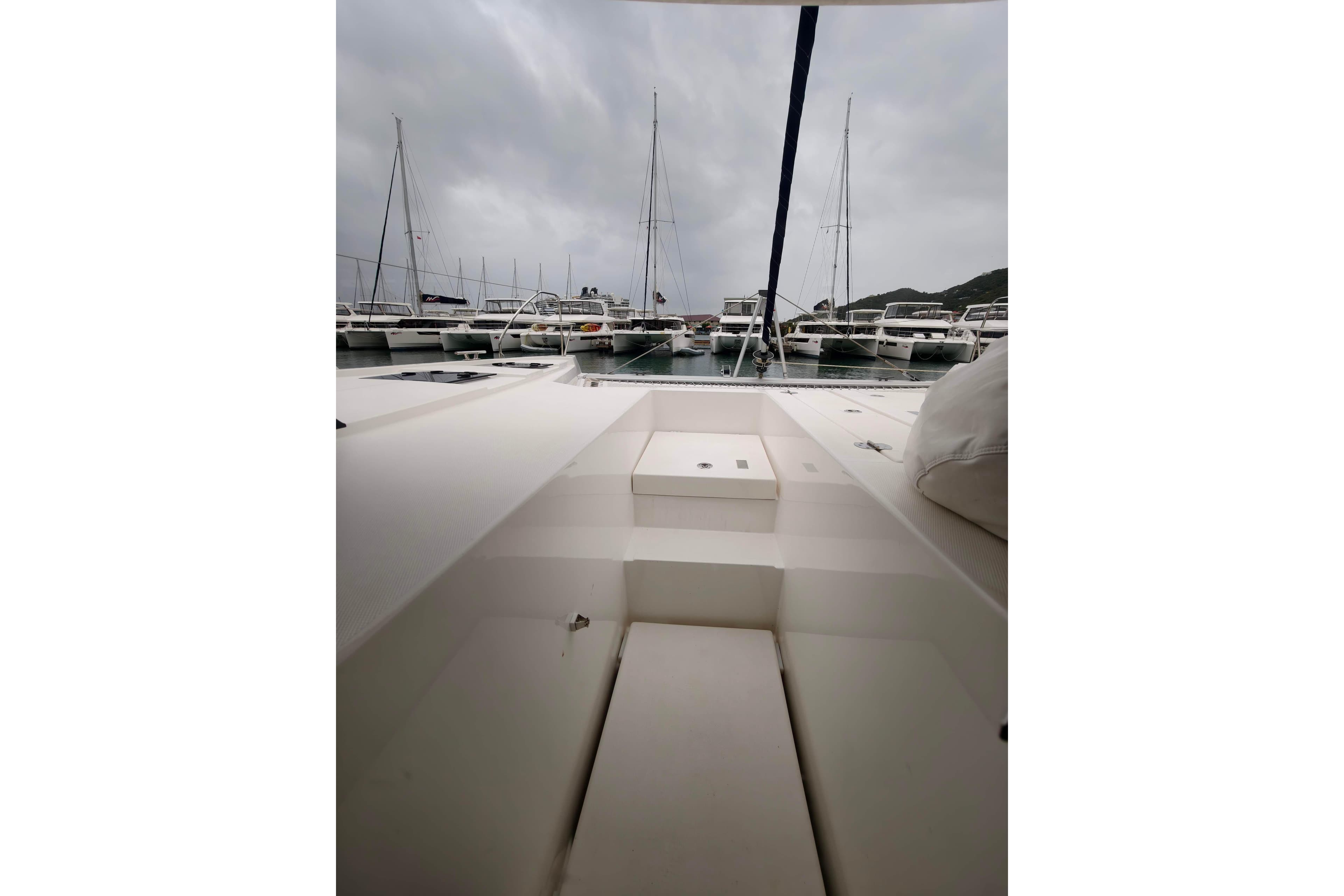 2025 Leopard 42 catamaran docked in a marina under cloudy skies.