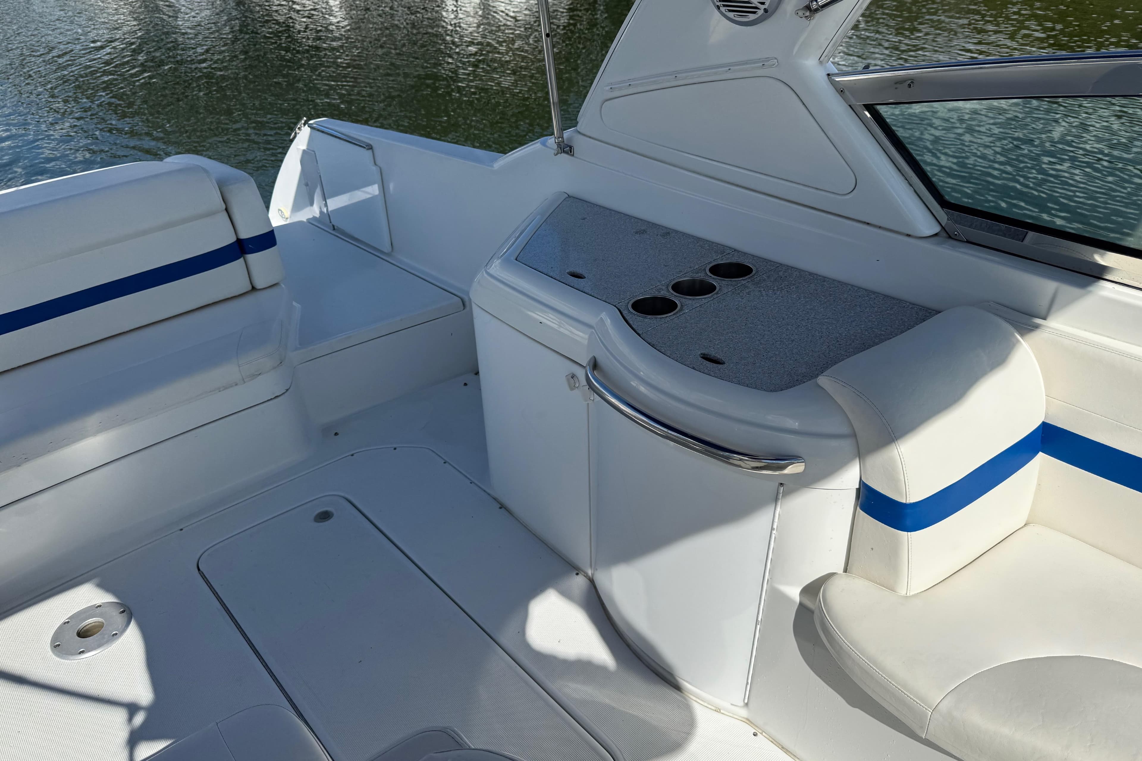 2004 Formula 330 Sun Sport boat interior with white seating and blue accents.