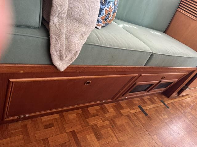 Interior of 1981 Grand Banks 36 Classic with wooden flooring and cushioned seating.