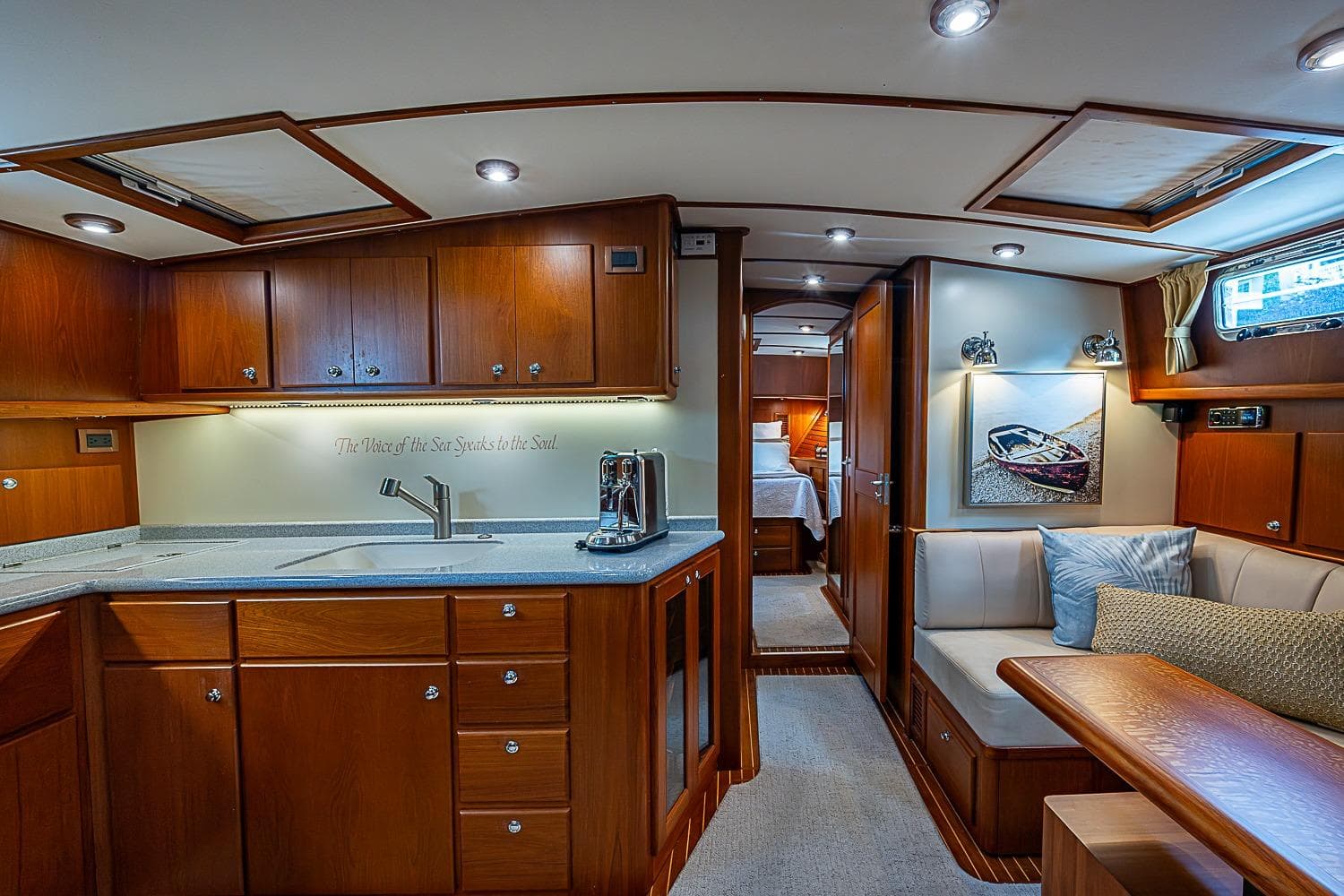 Luxurious 2004 Grand Banks 49 Eastbay HX yacht interior with elegant wood cabinetry and cozy seating.