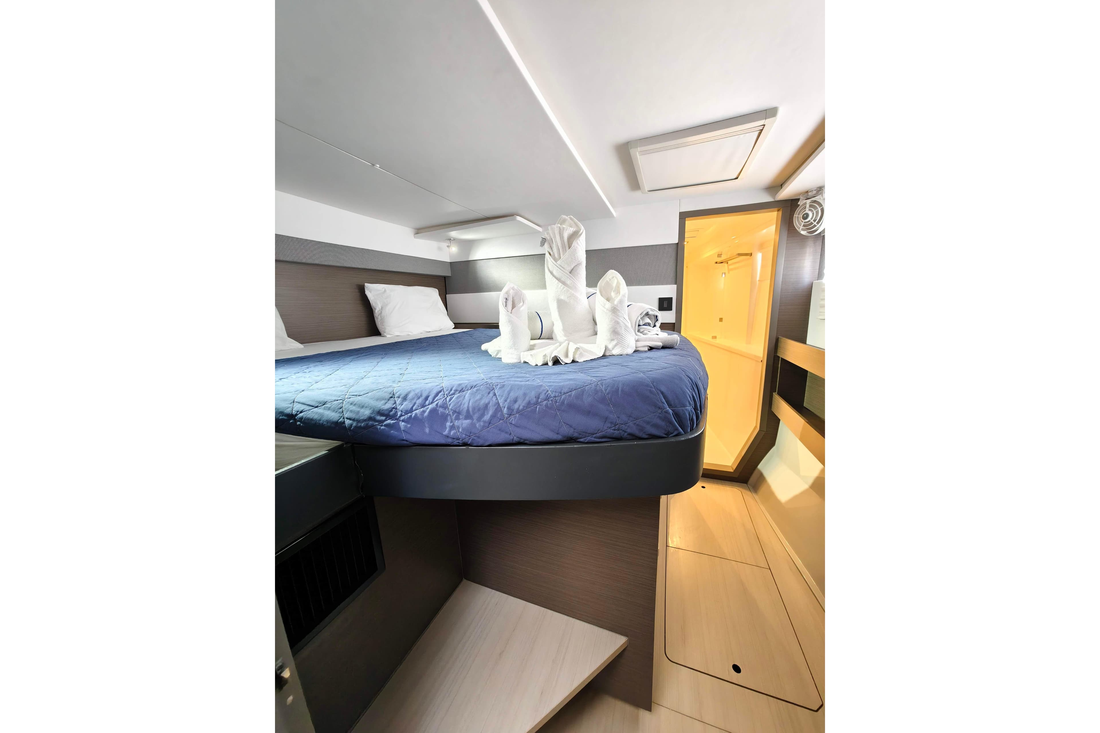Luxurious cabin interior of 2021 Leopard 50 yacht with elegant bedding and towel art.