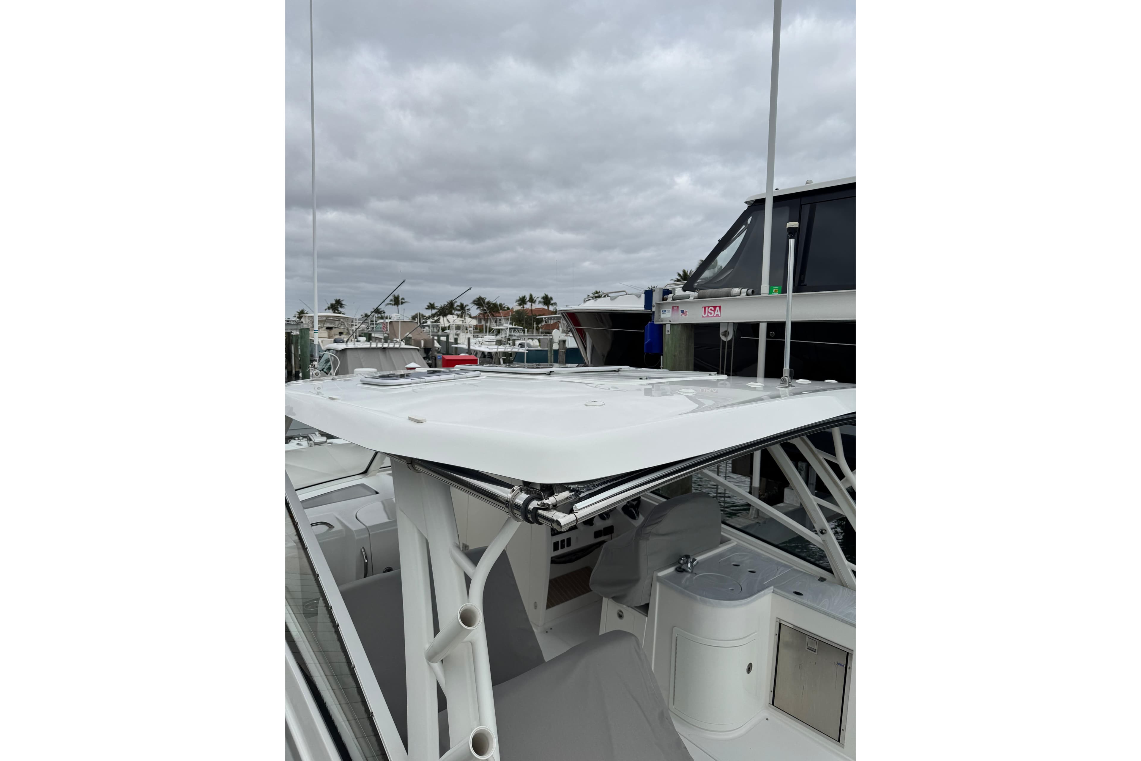 2022 World Cat 325 DC boat docked, showcasing sleek design and spacious deck under cloudy skies.