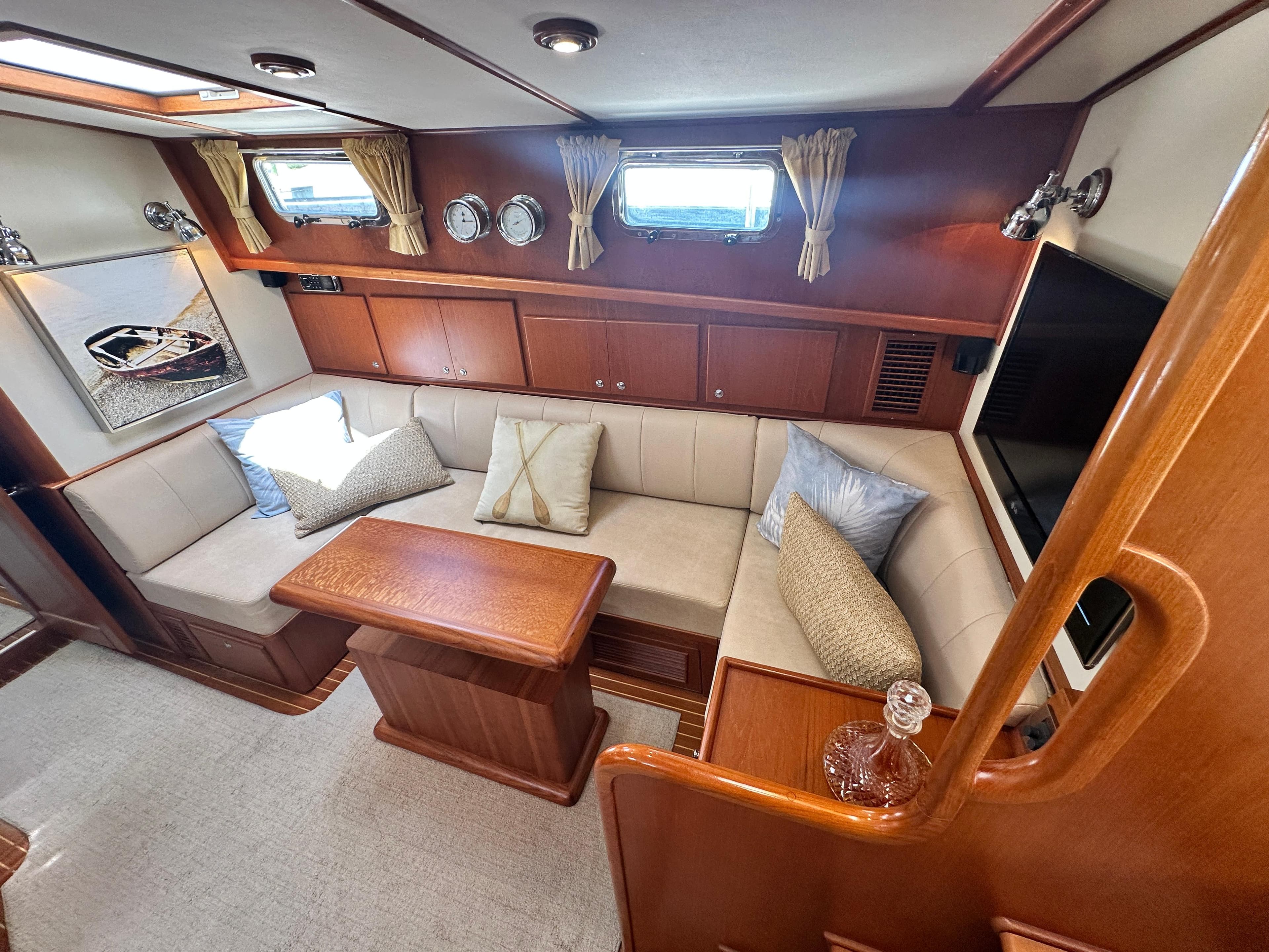Luxurious 2004 Grand Banks 49 Eastbay HX yacht interior with plush seating and elegant wood finishes.