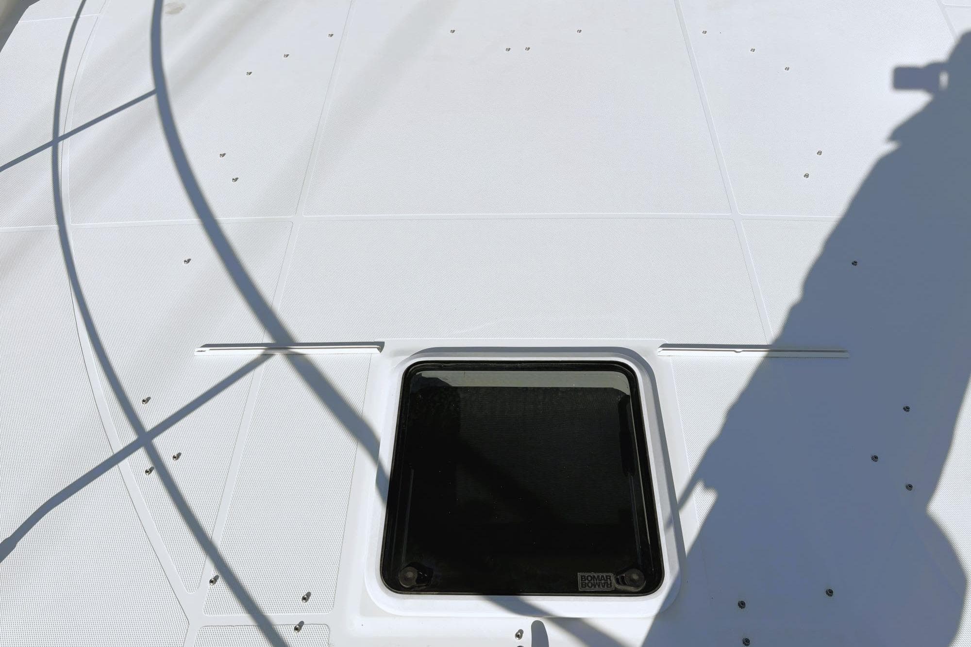 Deck of 2016 Carver C40 yacht with hatch and shadows.