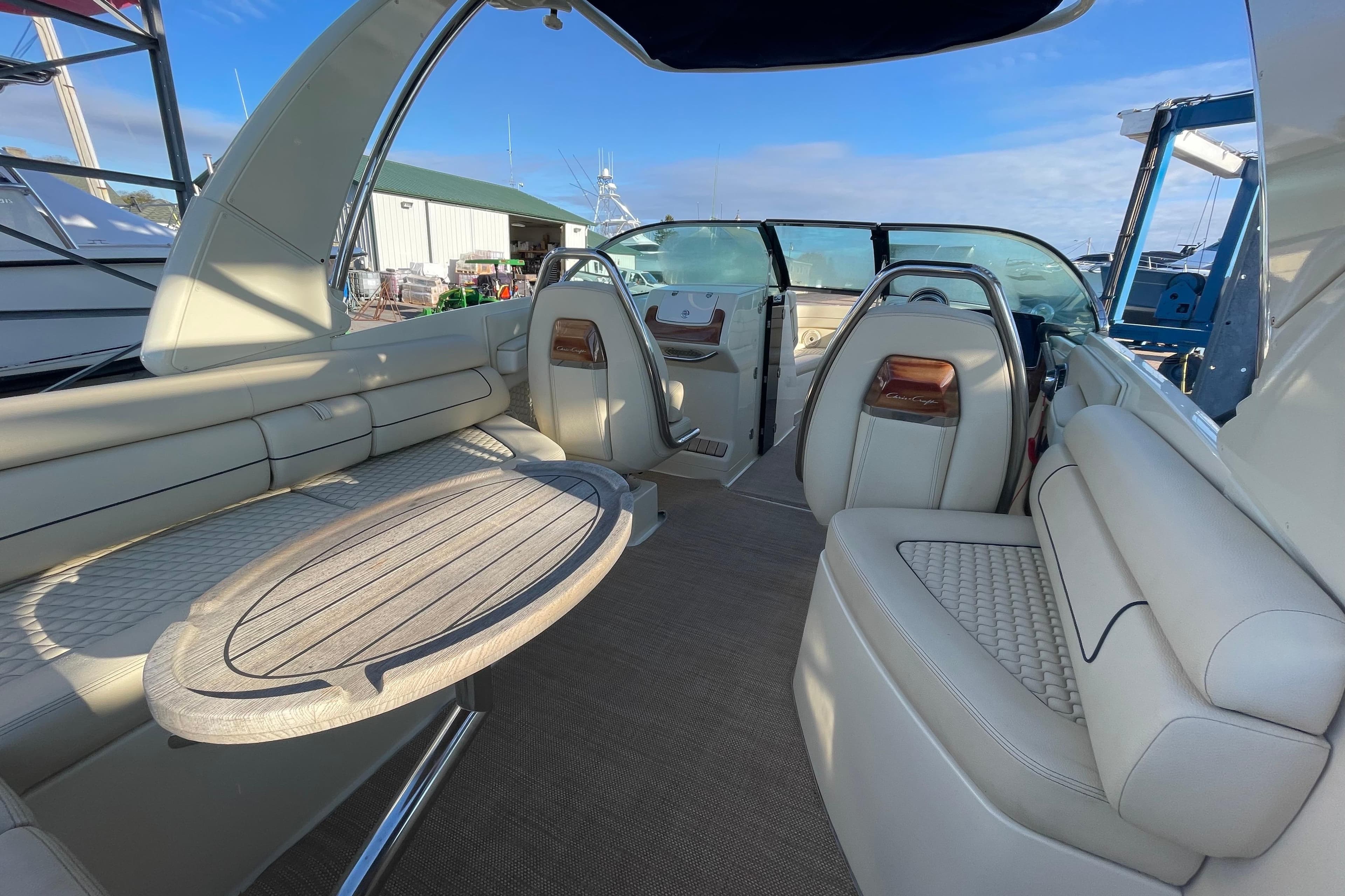 2020 Chris-Craft Launch 28 GT interior with elegant seating and wooden table.