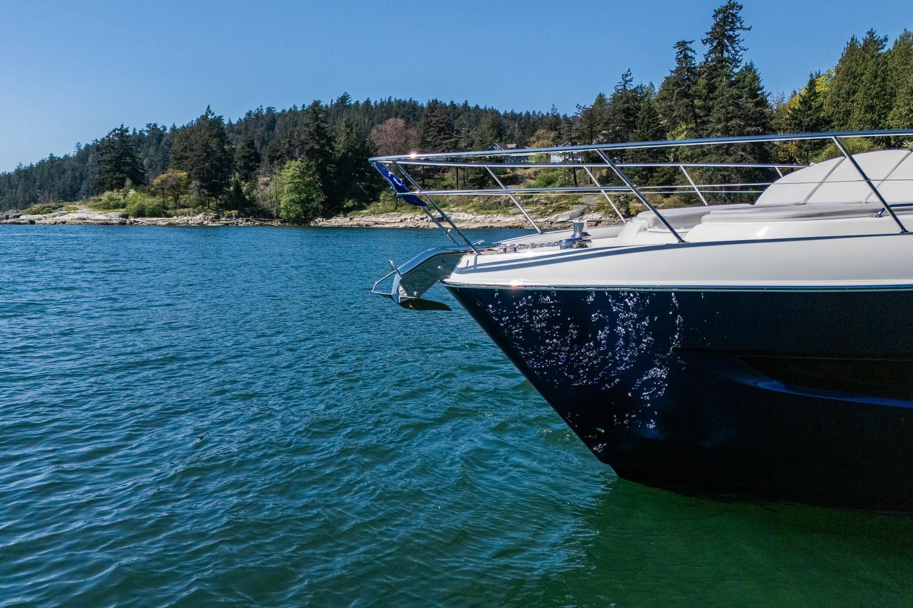 2026 Riviera 4600 Sport Yacht Platinum Edition cruising on a scenic lake.
