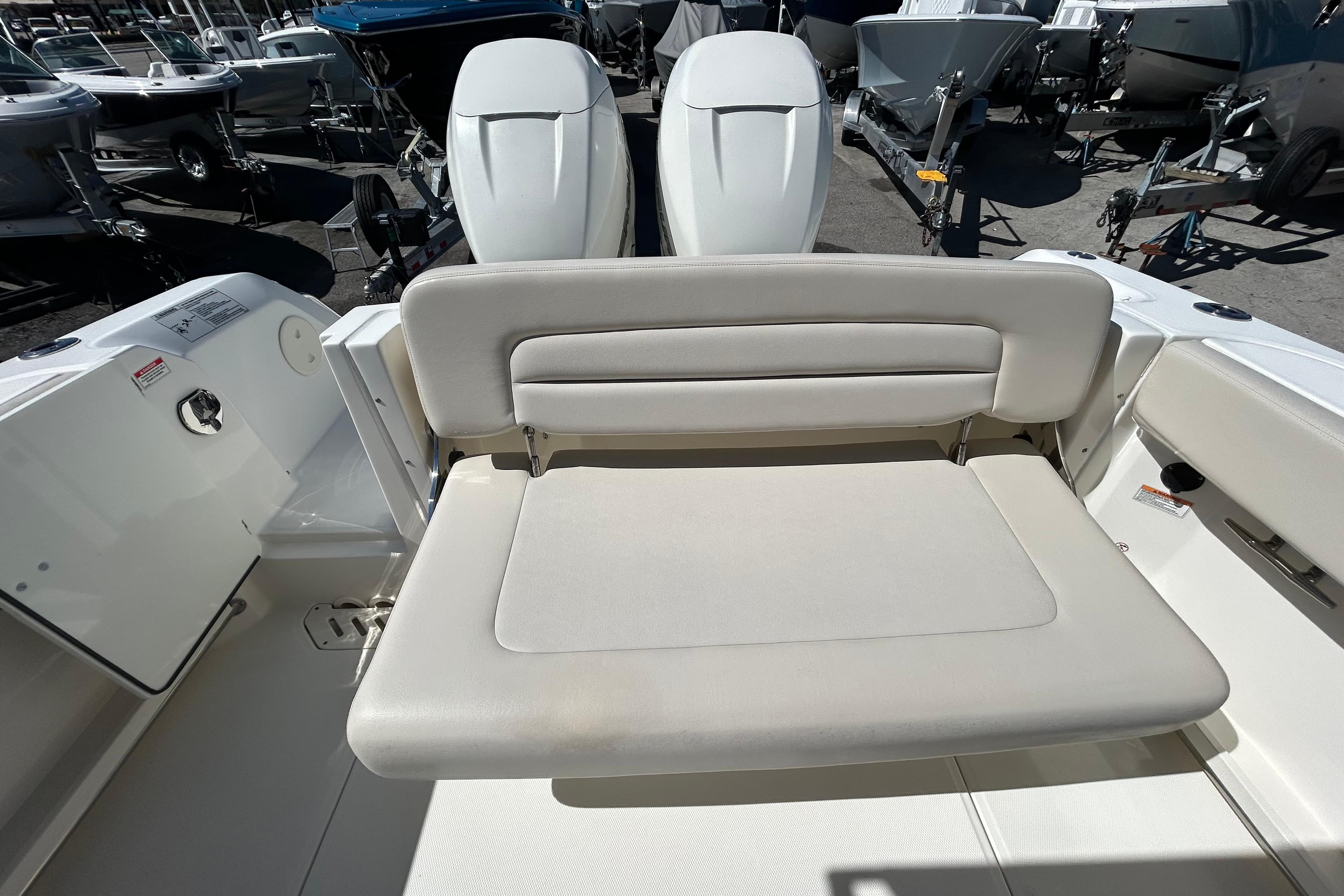 2018 Boston Whaler 270 Vantage boat interior with cushioned seating and dual engines.