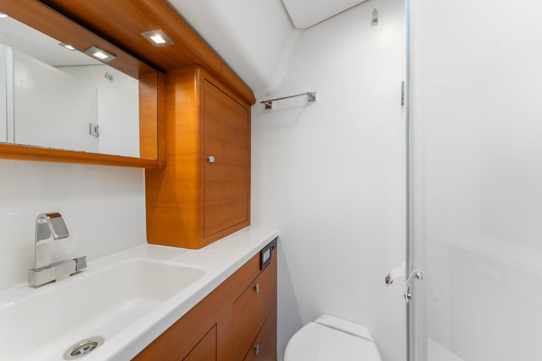 Luxurious 2015 Italia Yachts 13.98 bathroom with sleek wood cabinetry and modern fixtures.