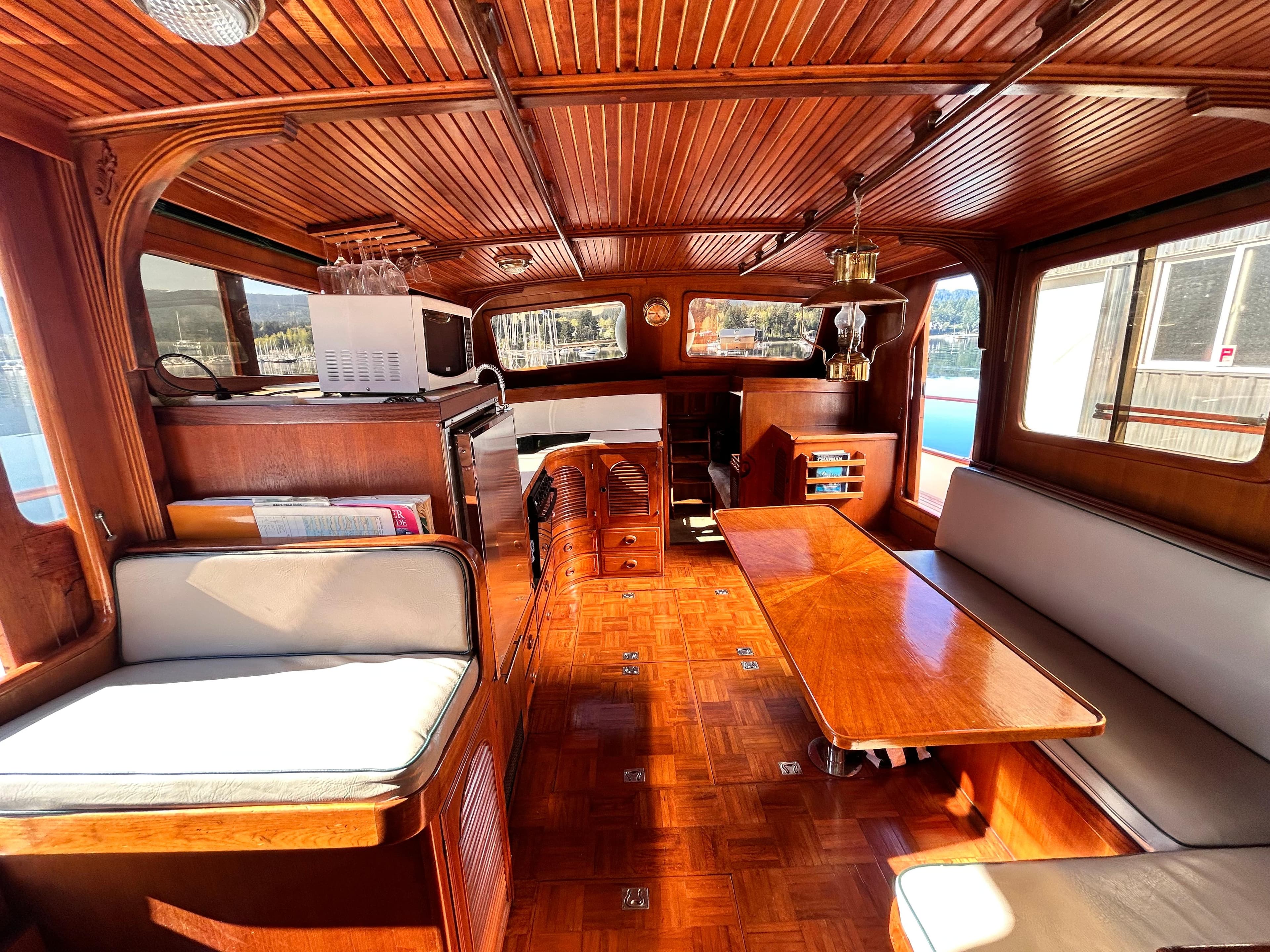 Interior of 1989 Albin 43 Trawler with wooden furnishings and seating area.