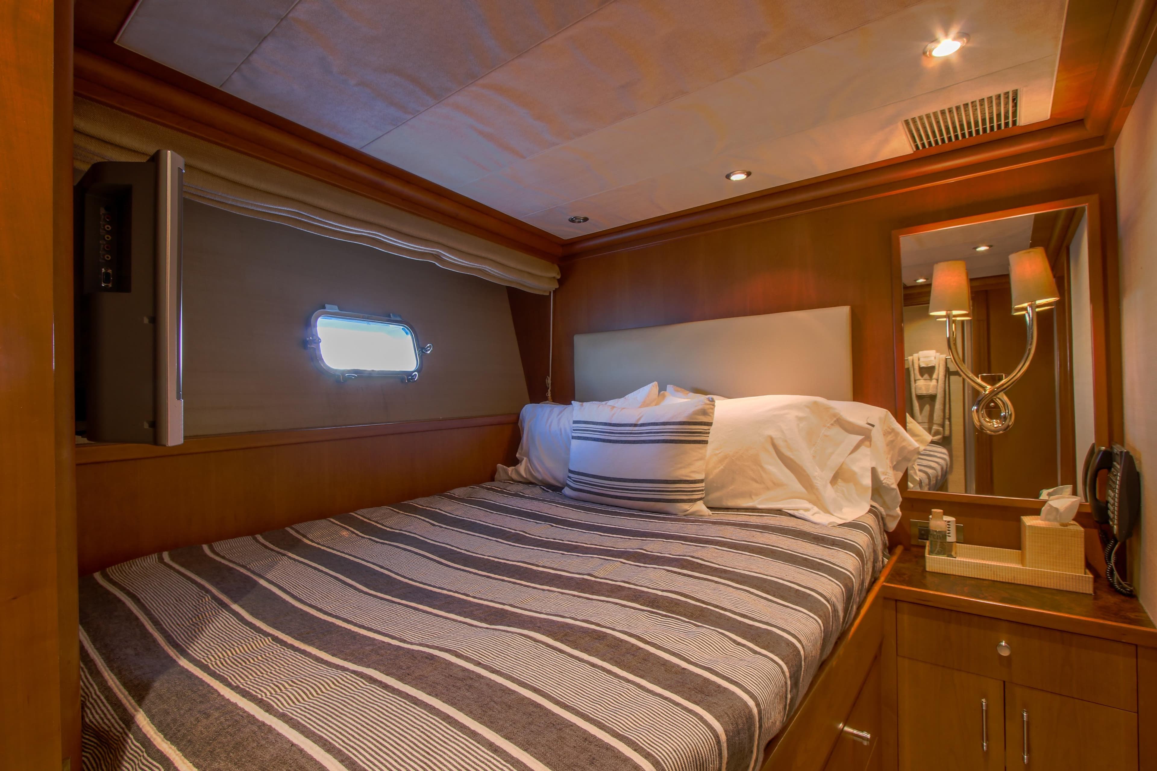 Luxurious 2006 Northcoast Yachts Yachtfisher cabin with cozy bed and elegant lighting.