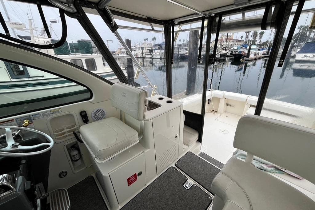 Interior view of a 2005 Pursuit 3100 Offshore boat at a marina.