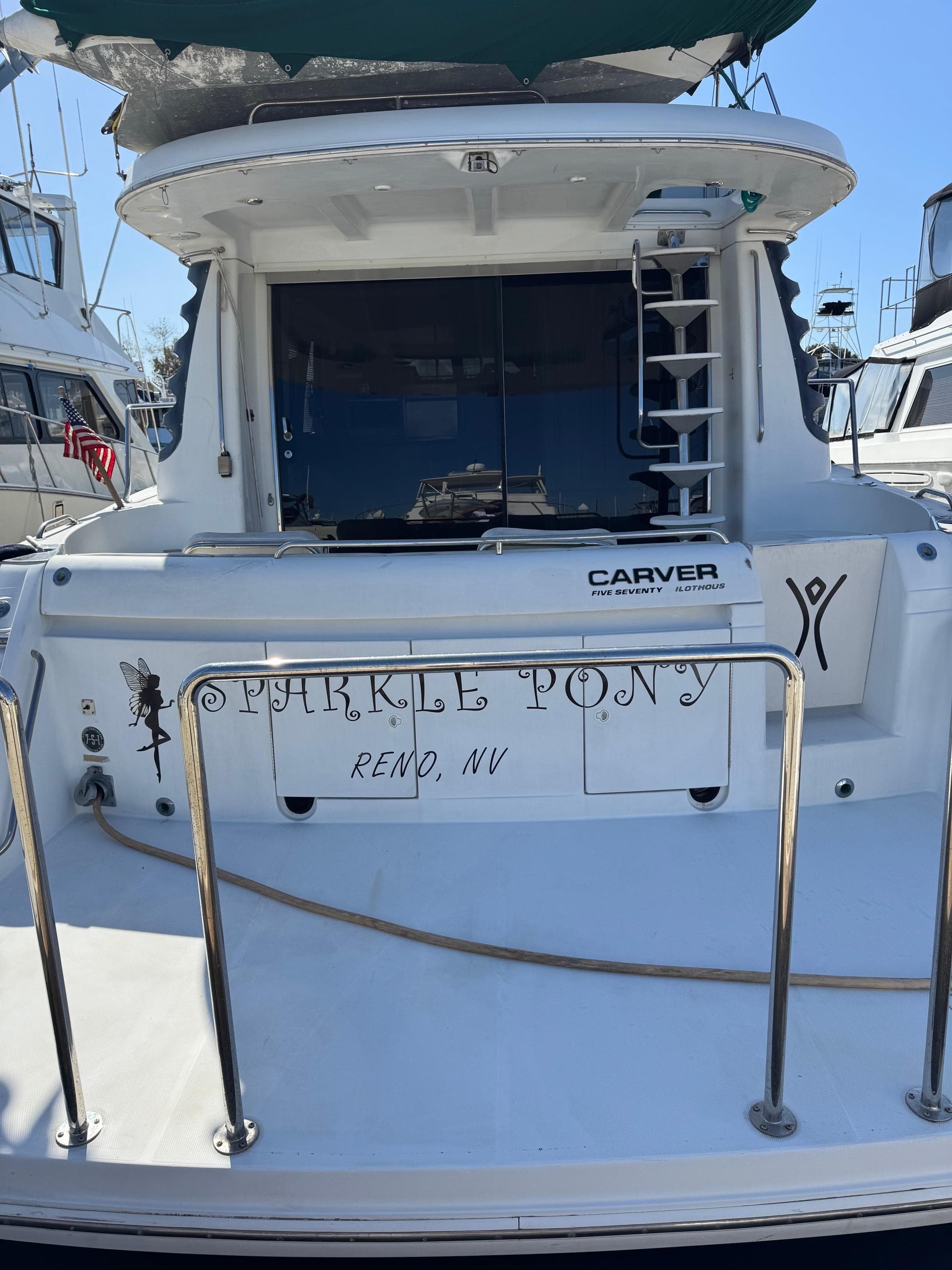 2002 Carver 570 Voyager Pilothouse yacht docked, rear view with "Sparkle Pony" name.