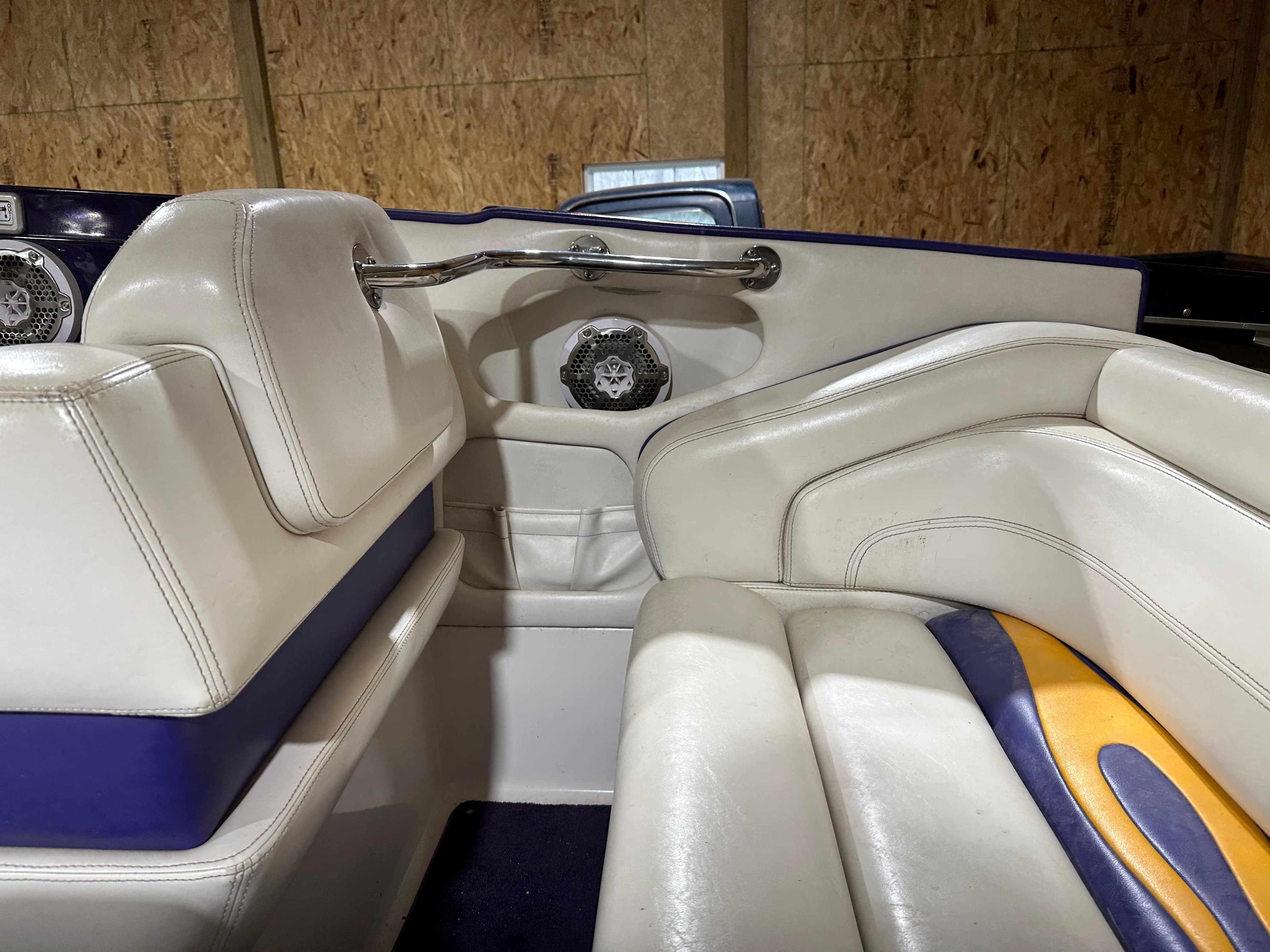 2005 Eliminator 260 Eagle XP boat interior with white and blue seating.