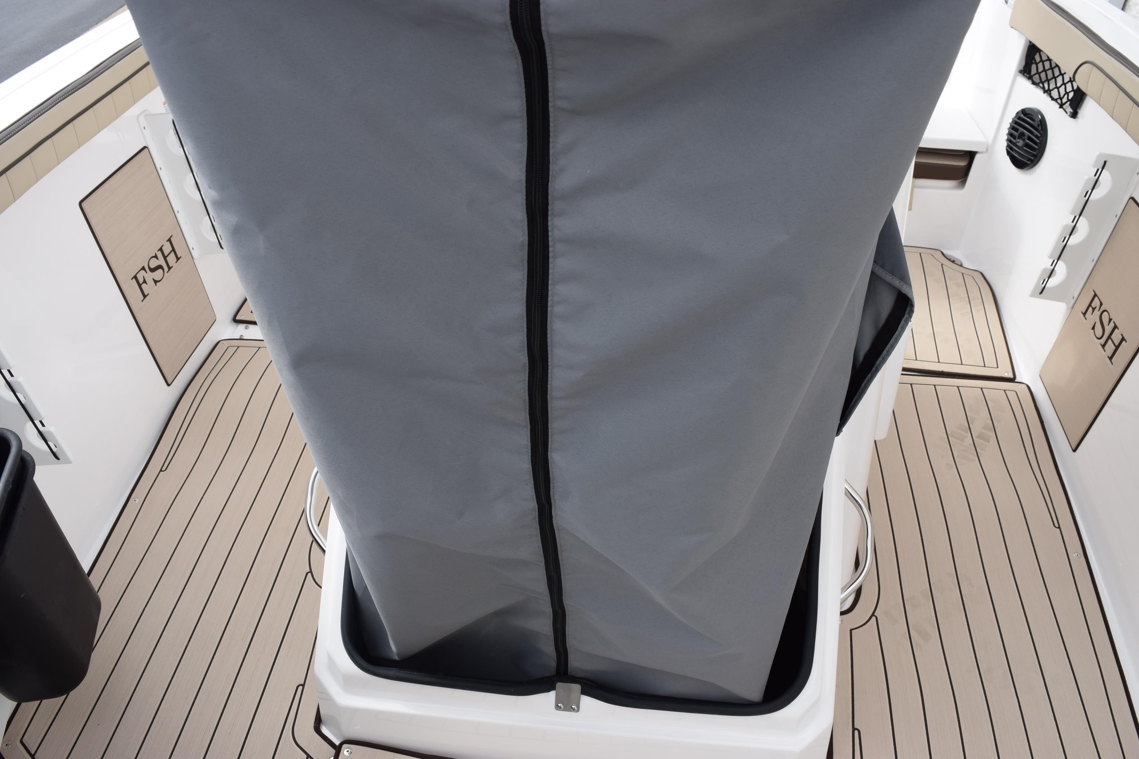 2026 Yamaha Boats 222 FSH Sport E interior with covered console and teak-style flooring.