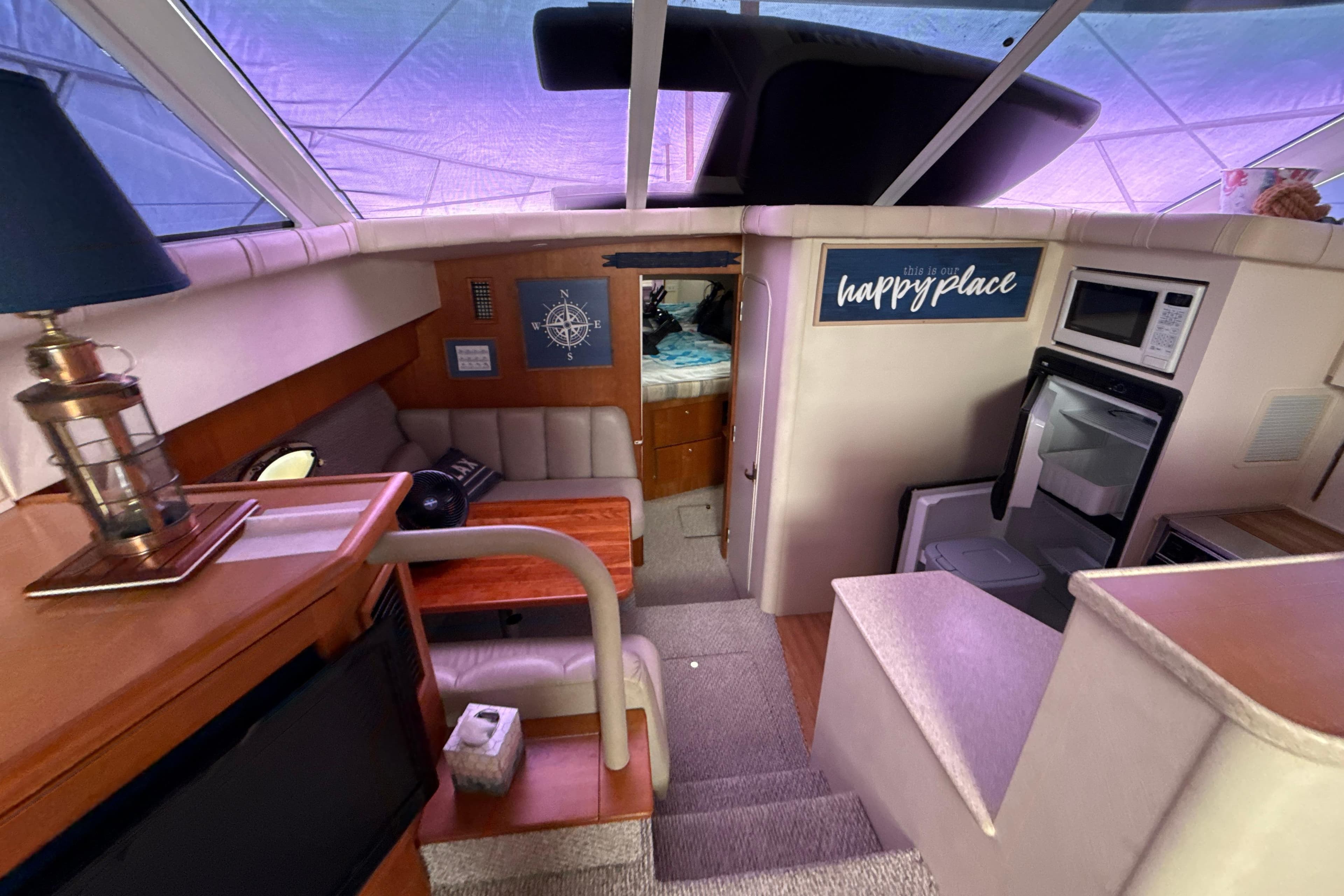 Interior of a 1999 Silverton 422 Motor Yacht with cozy seating and kitchen area.