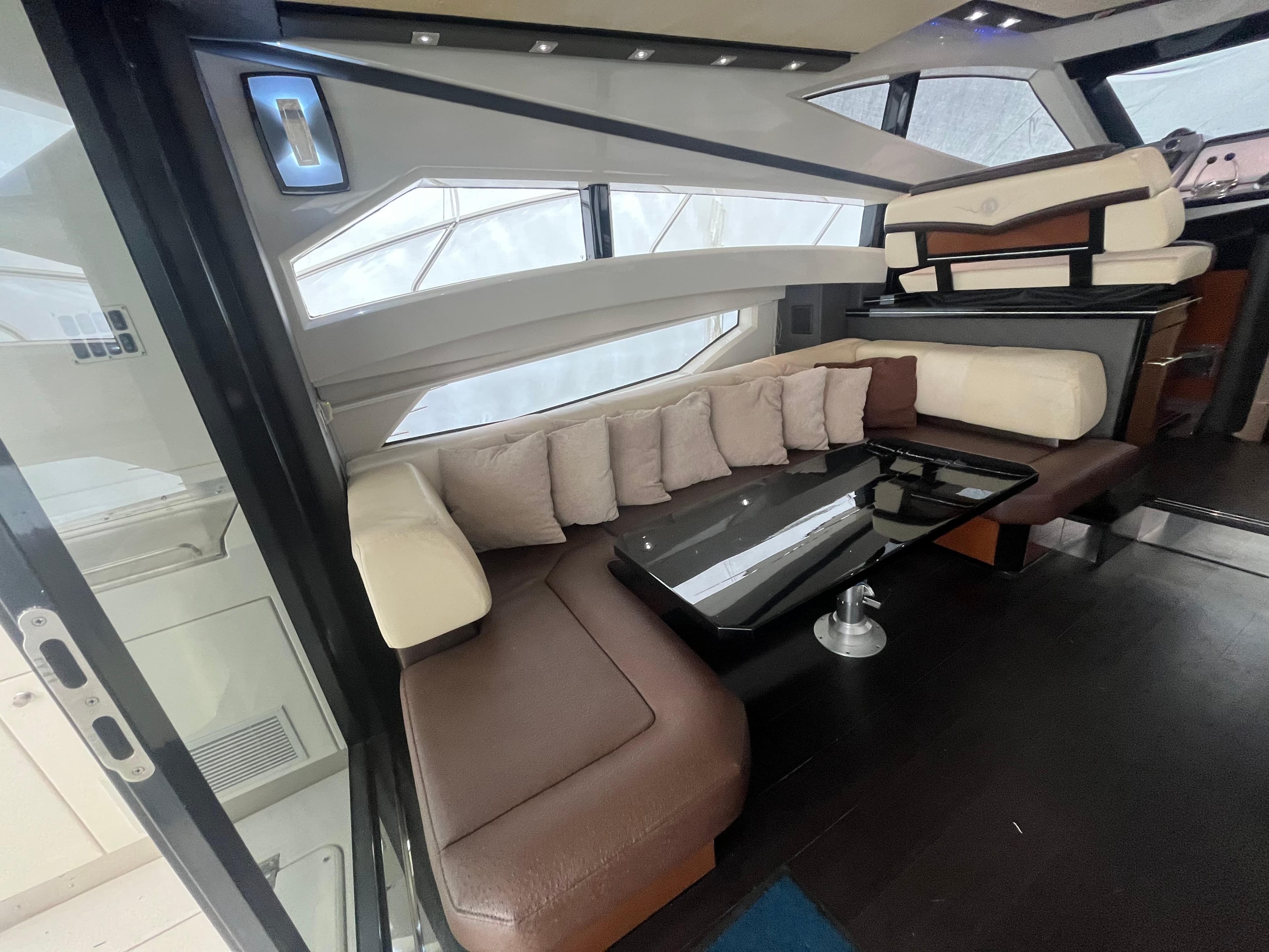 Luxurious interior of 2010 Marquis 500 Sport Bridge yacht with plush seating and modern design.