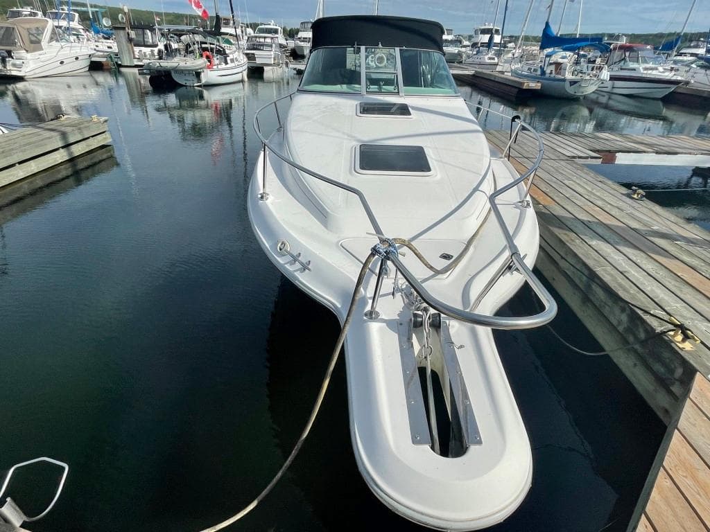 1995 Sea Ray 270 Sundancer docked in a marina, surrounded by other boats.