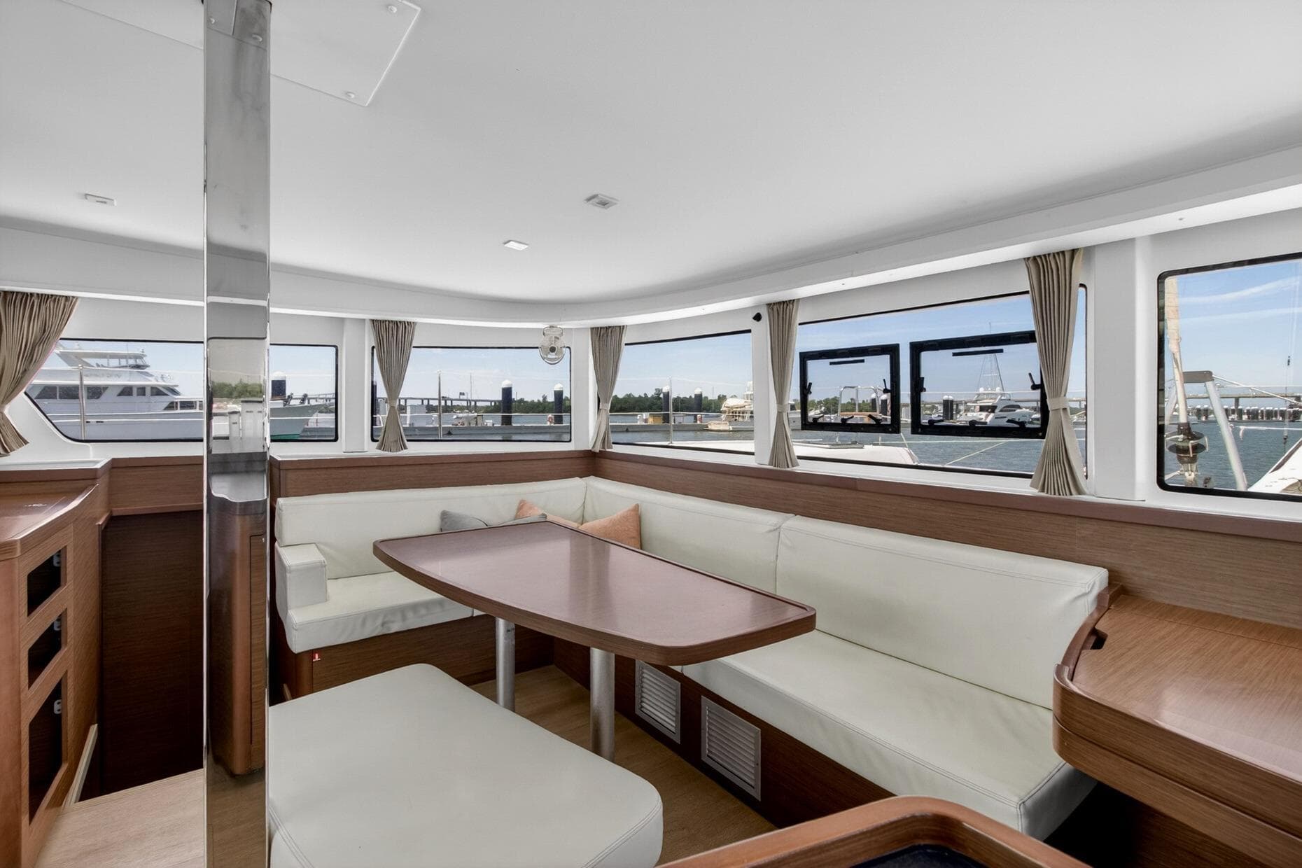 Interior of 2018 Lagoon 42 catamaran with spacious seating and panoramic windows.