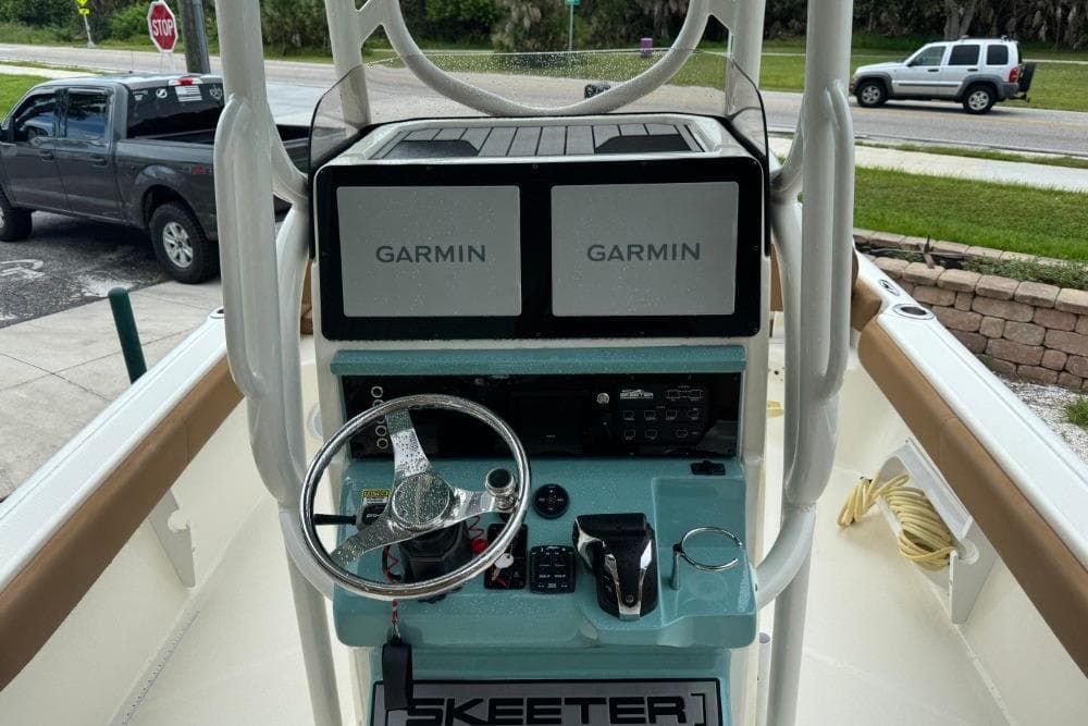2021 Skeeter SX2550 Family boat dashboard with dual Garmin displays and steering wheel.