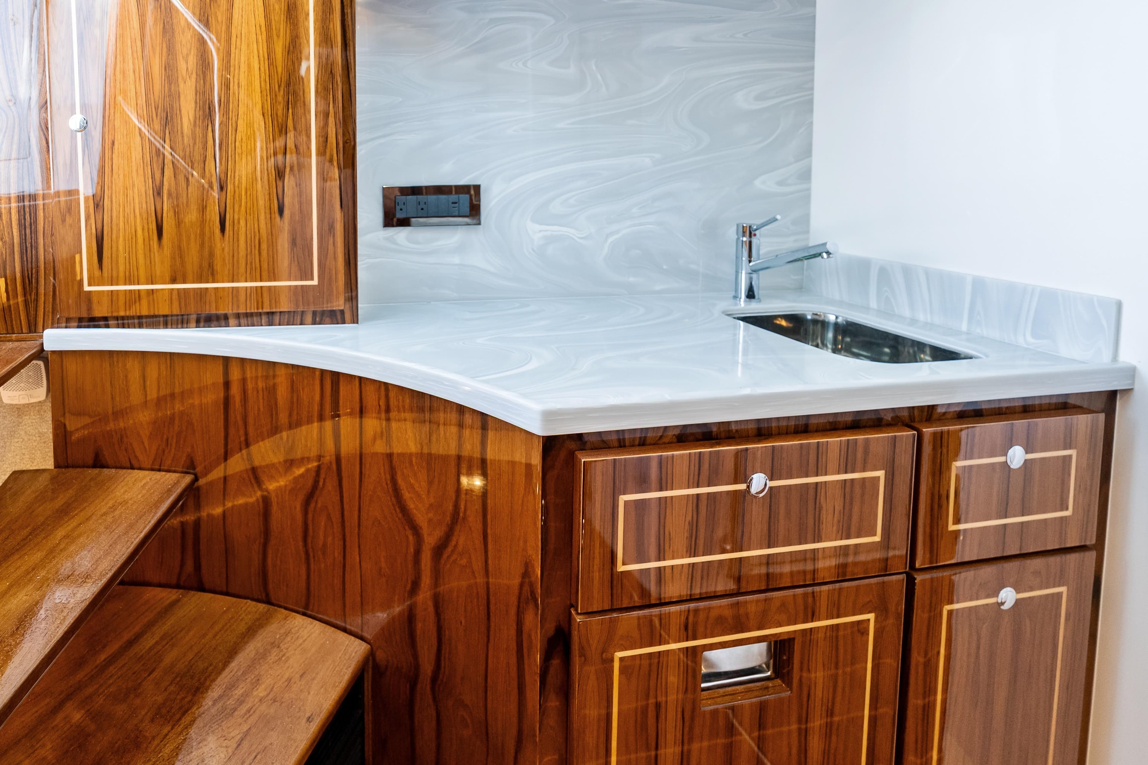 Luxurious wooden cabinetry and sleek sink in 2025 HCB 56 Suenos GIX yacht interior.