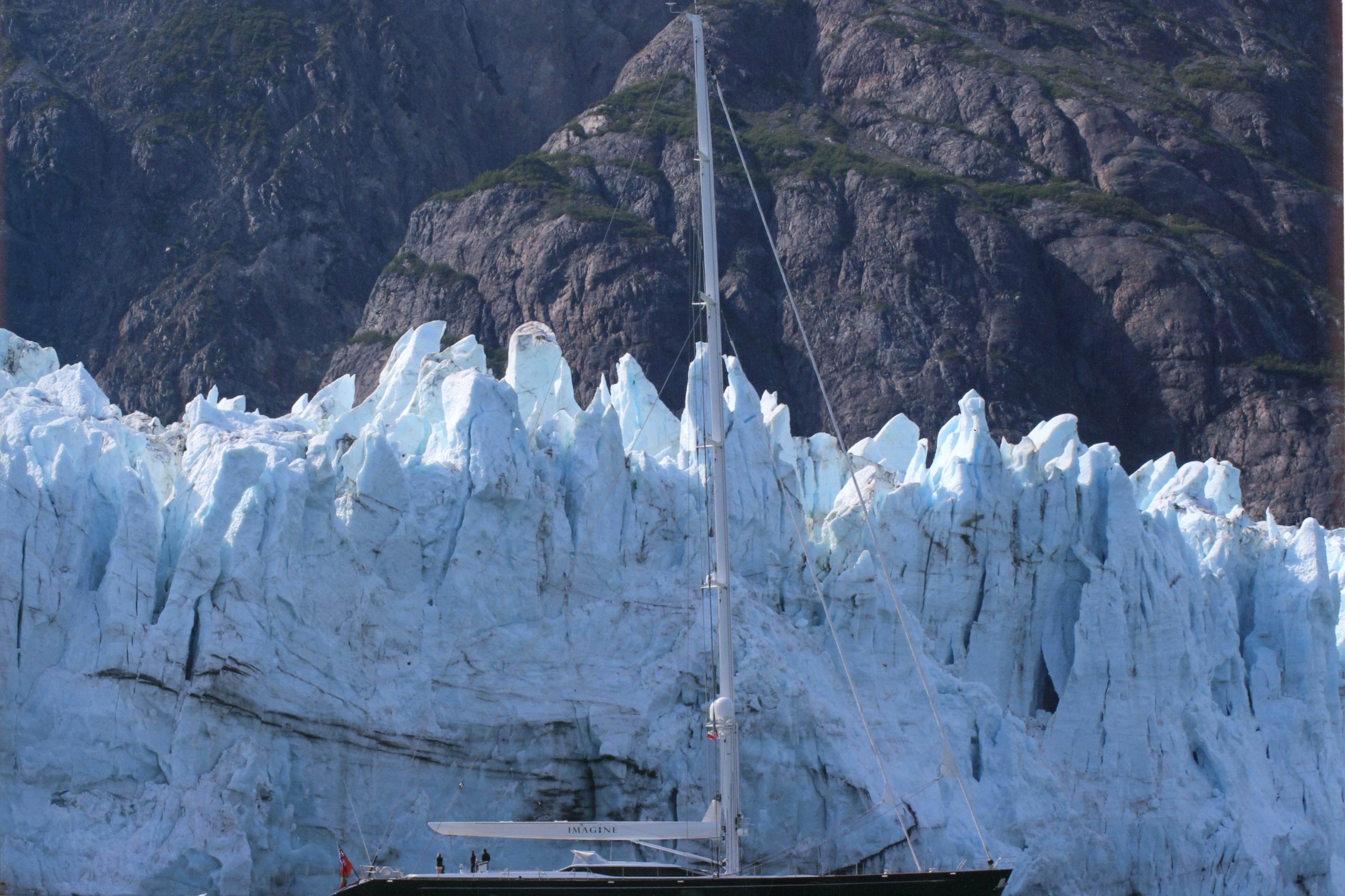 Sailing yacht Alloy Yachts AY 40 (2010) near a majestic glacier backdrop.