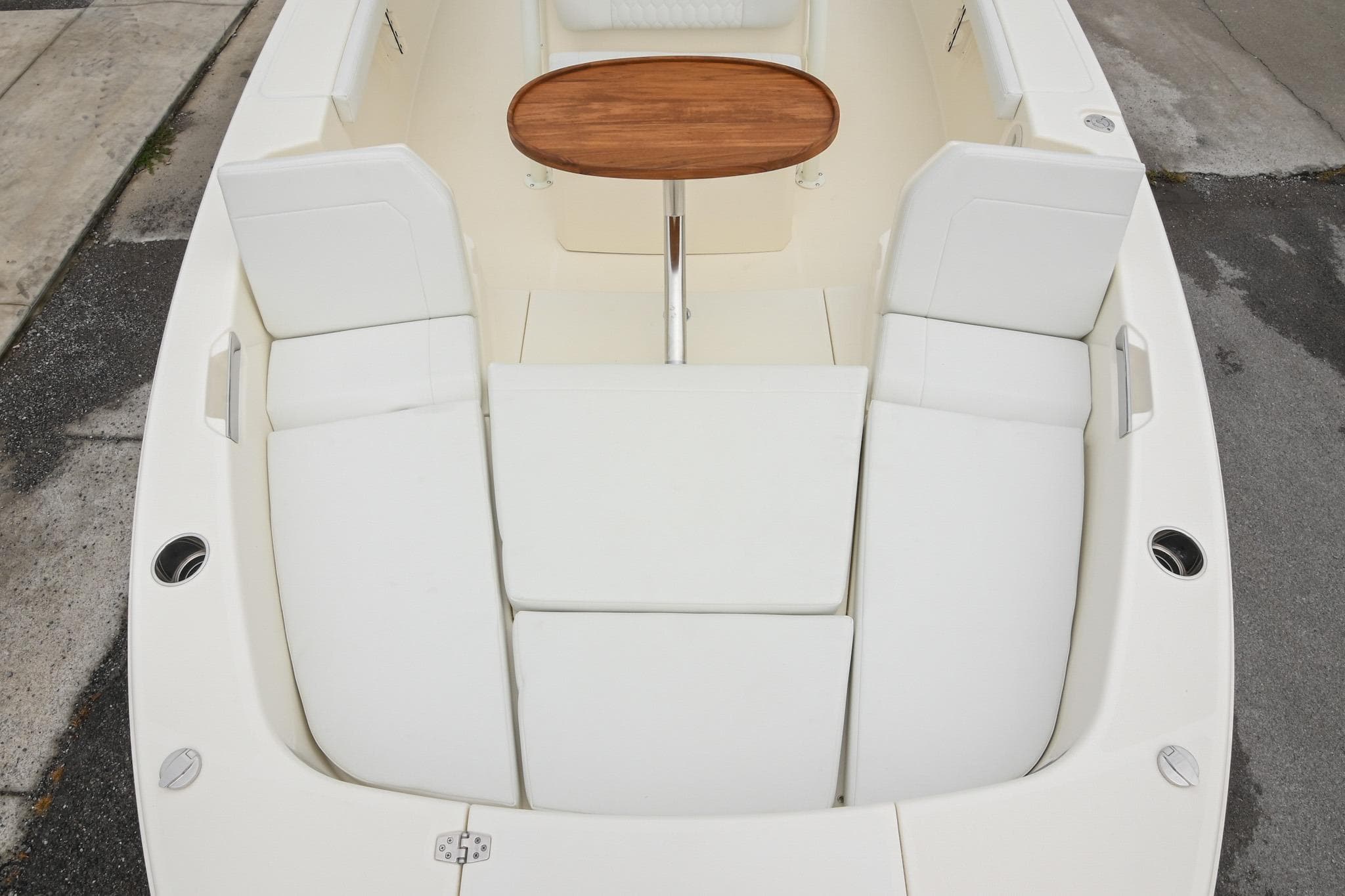 2026 Pathfinder 2400 TRS boat interior with white seating and wooden table.