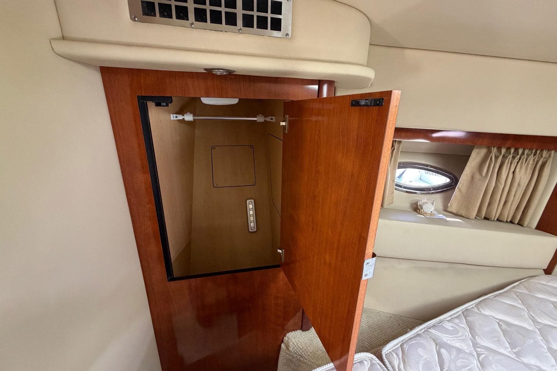 2007 Sea Ray 36 Sedan Bridge interior closet with open wooden door.