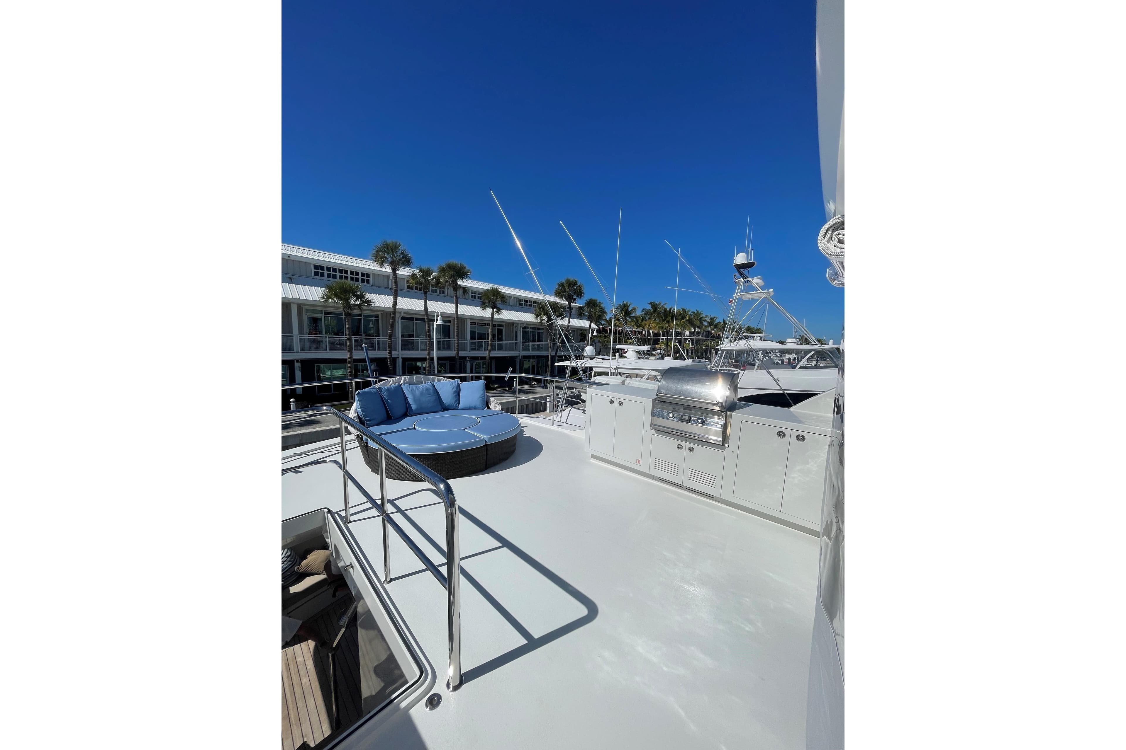 Luxurious 2012 Cheoy Lee 84 Bravo yacht deck with seating and grill under clear blue sky.