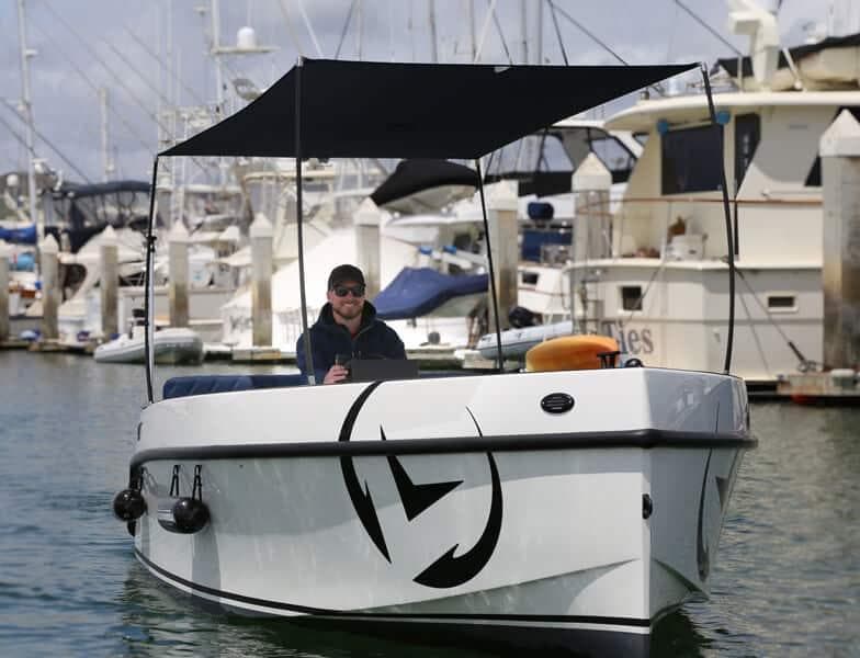2023 Vision Marine Technologies Volt 180 boat docked at marina with canopy.