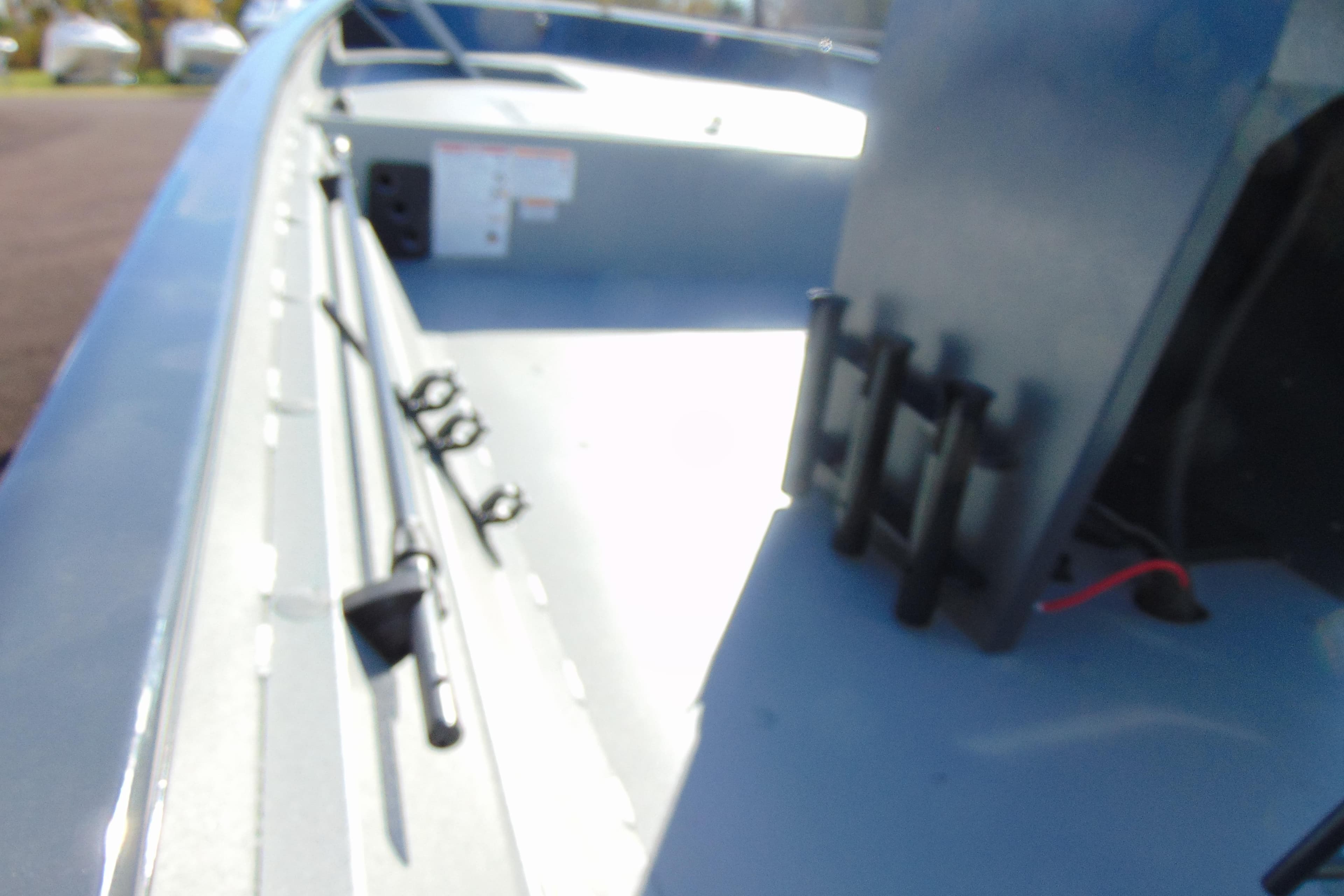 Interior view of 2026 Crestliner 2070 Retriever CC boat, showcasing rod holders and deck layout.