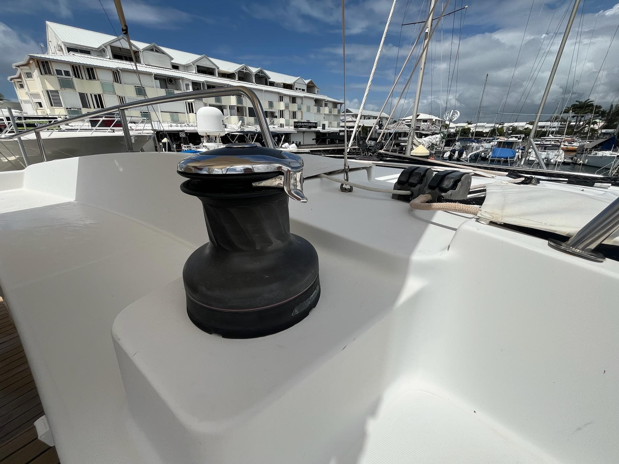 2009 Lagoon 440 yacht deck with winch, docked in marina.