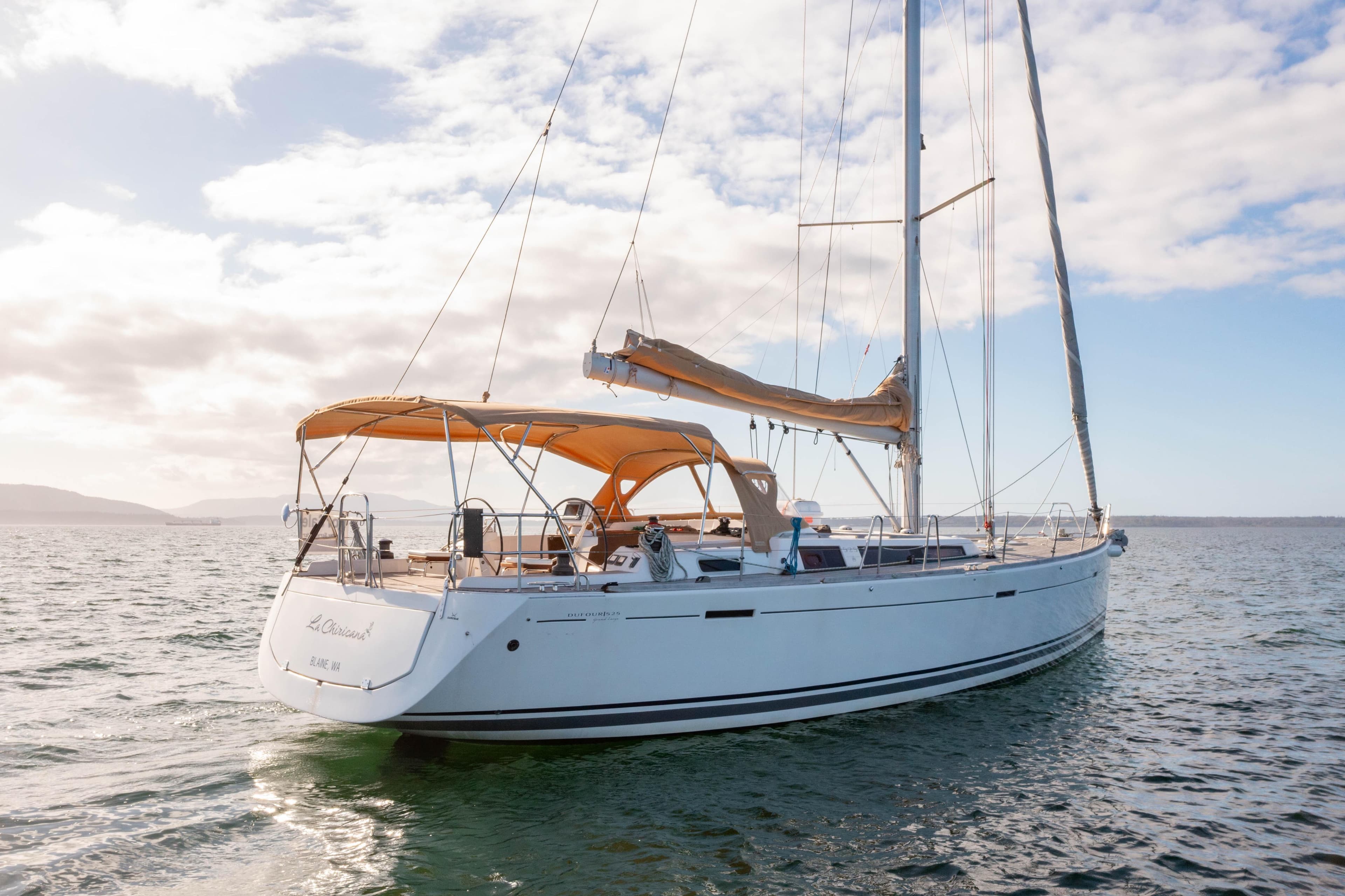 Sailing yacht Dufour 525 Grand Large 2011 on open water under a clear sky.
