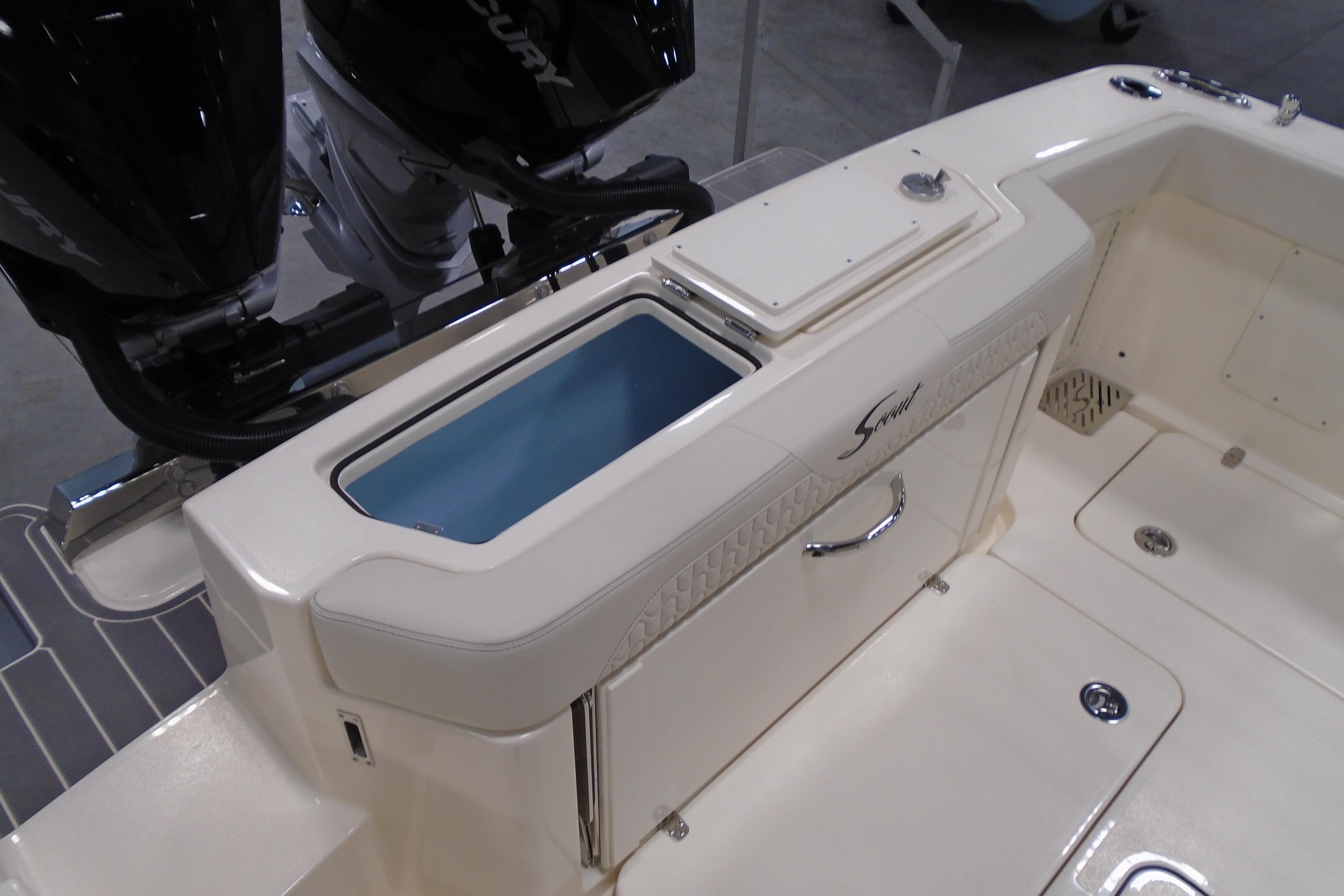 2026 Scout 288 LXF boat interior with storage compartment and dual Mercury engines.