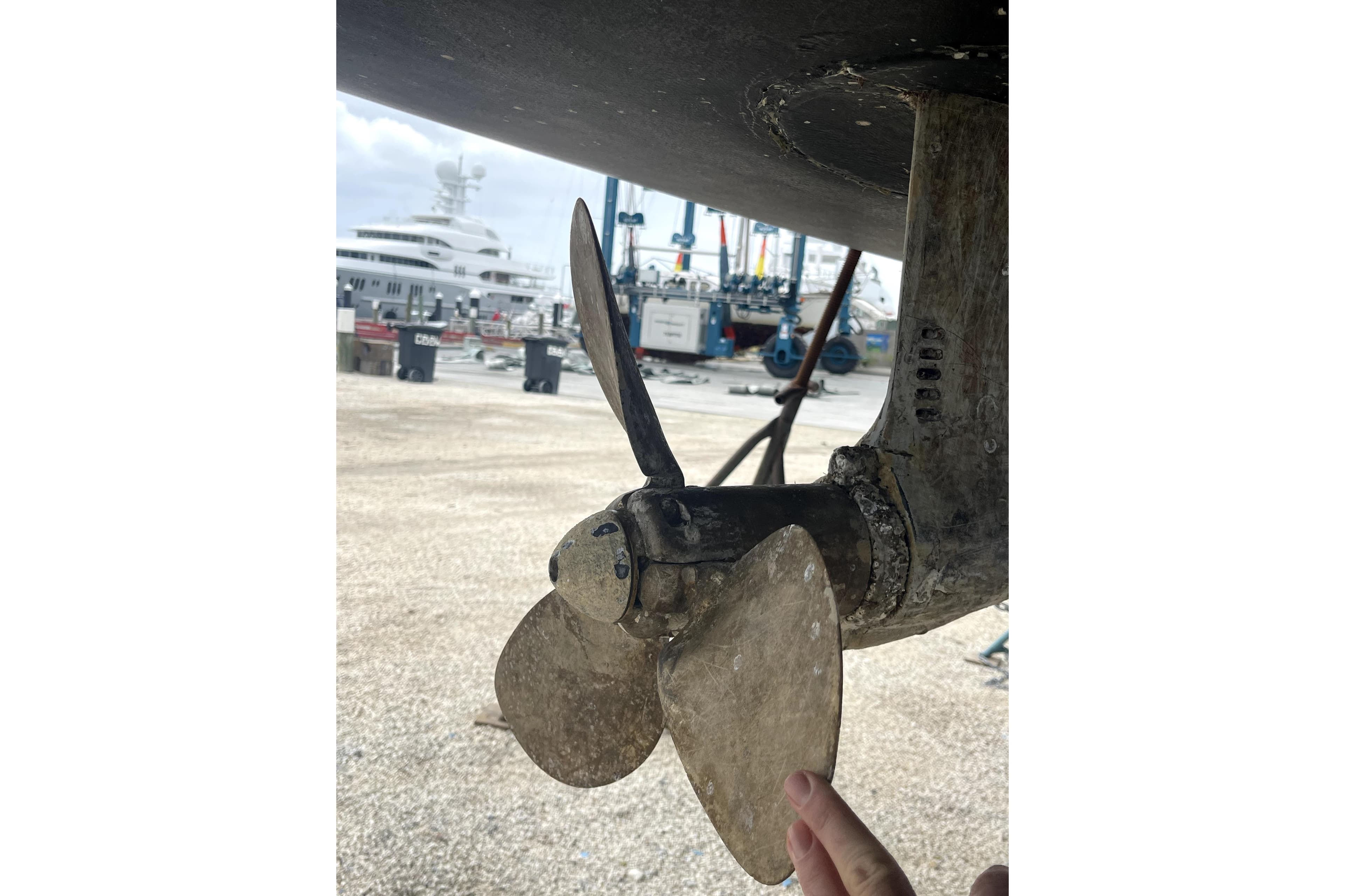Close-up of a 2013 Beneteau Sense 46 sailboat propeller in a marina setting.