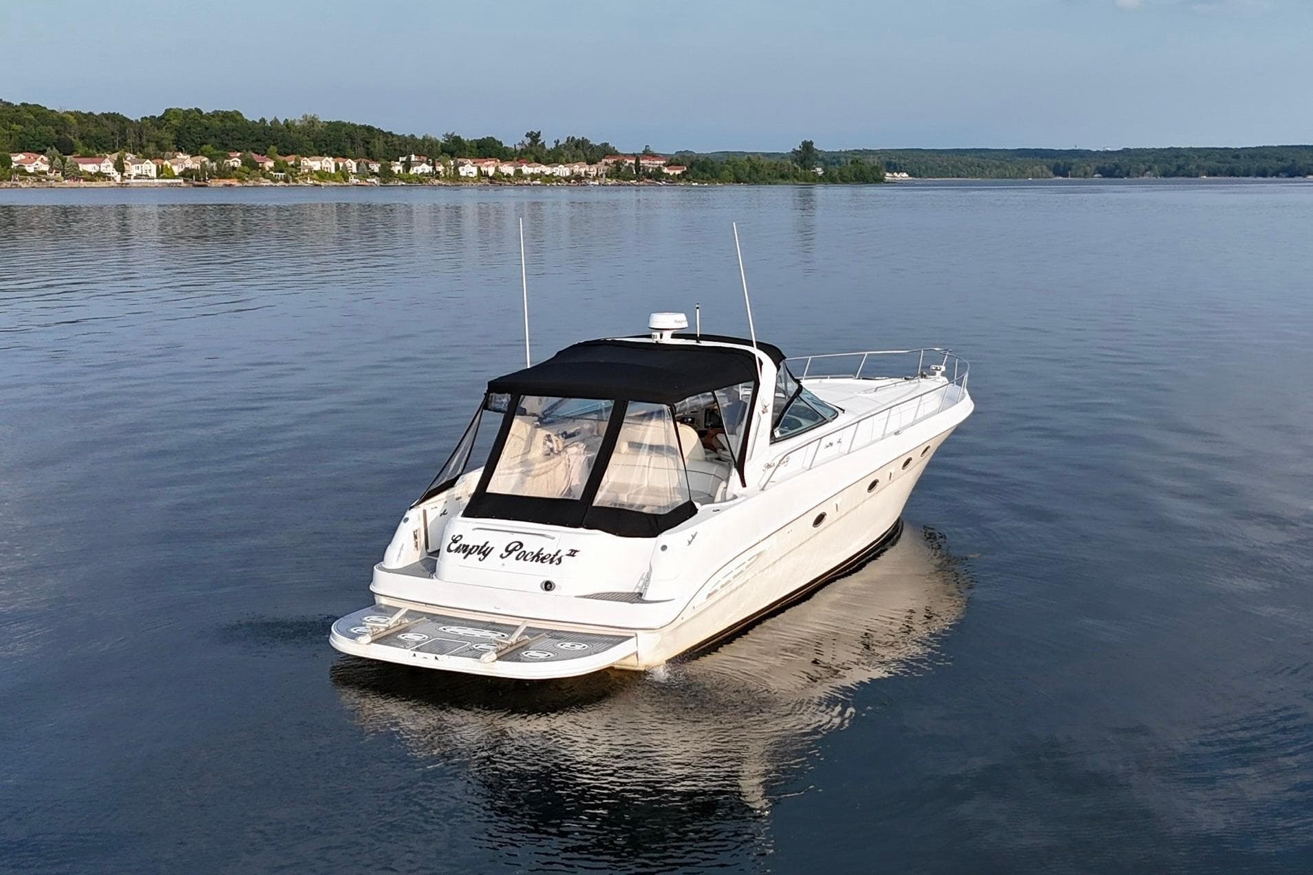 1999 Sea Ray 460 Sundancer yacht cruising on a calm lake.