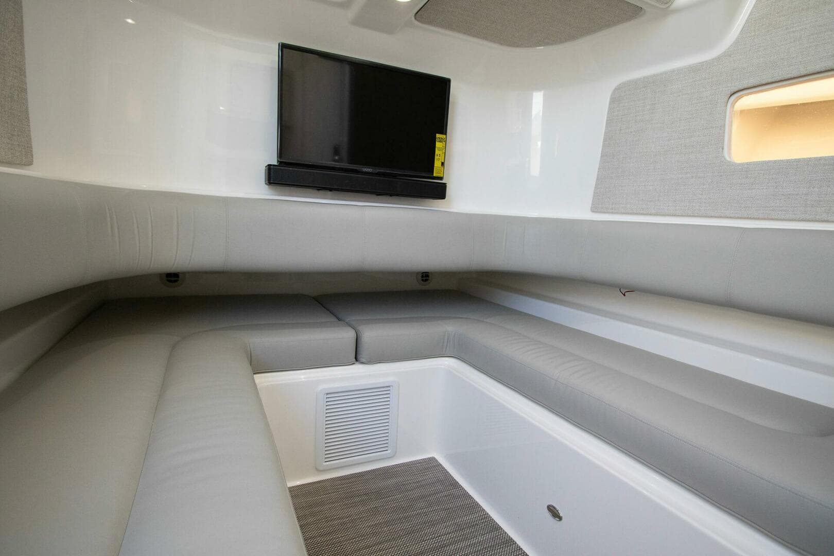 2025 Regulator 37 boat interior with gray seating and mounted TV.