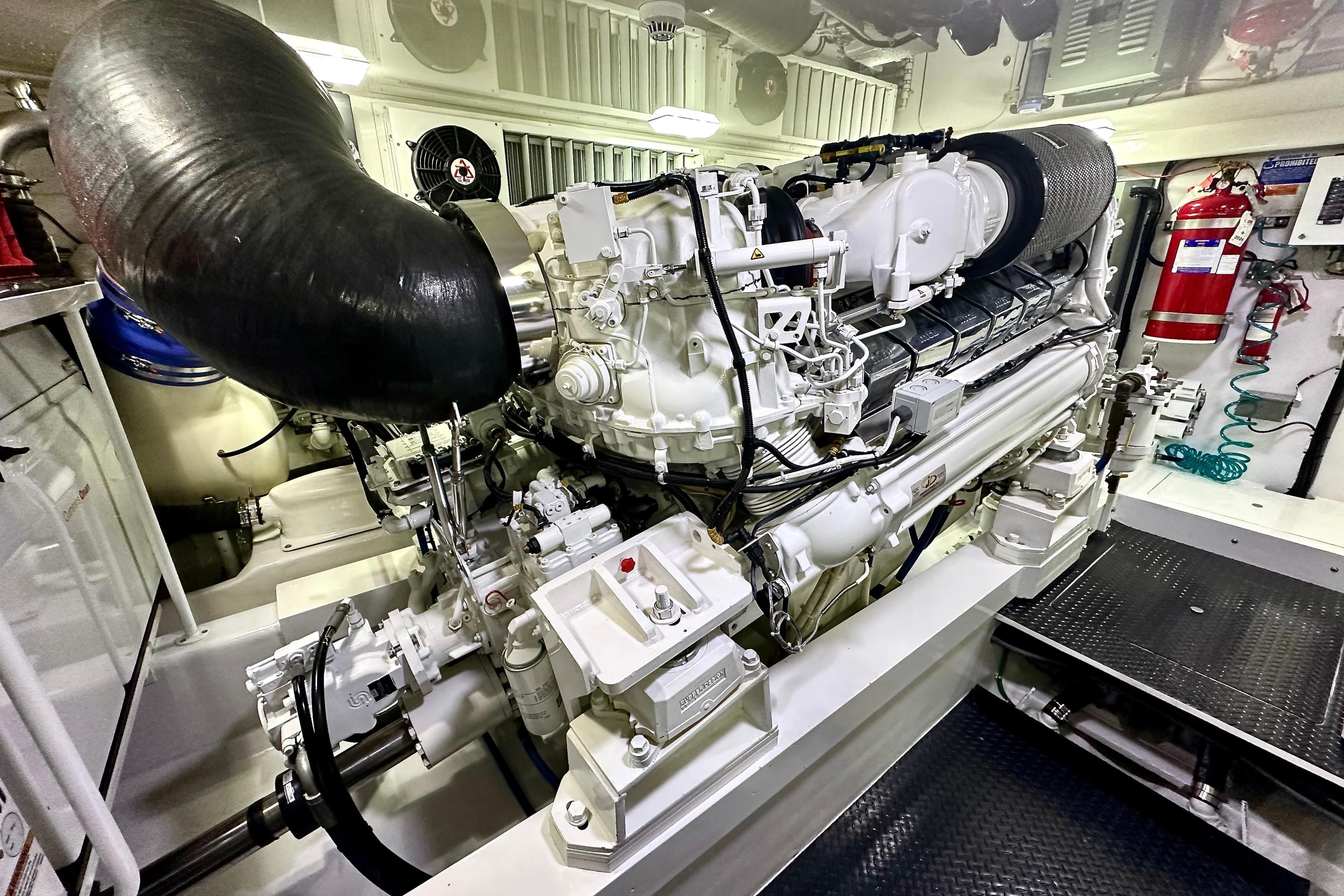 Engine room of 2019 Viking 68 Convertible yacht, showcasing powerful machinery and equipment.
