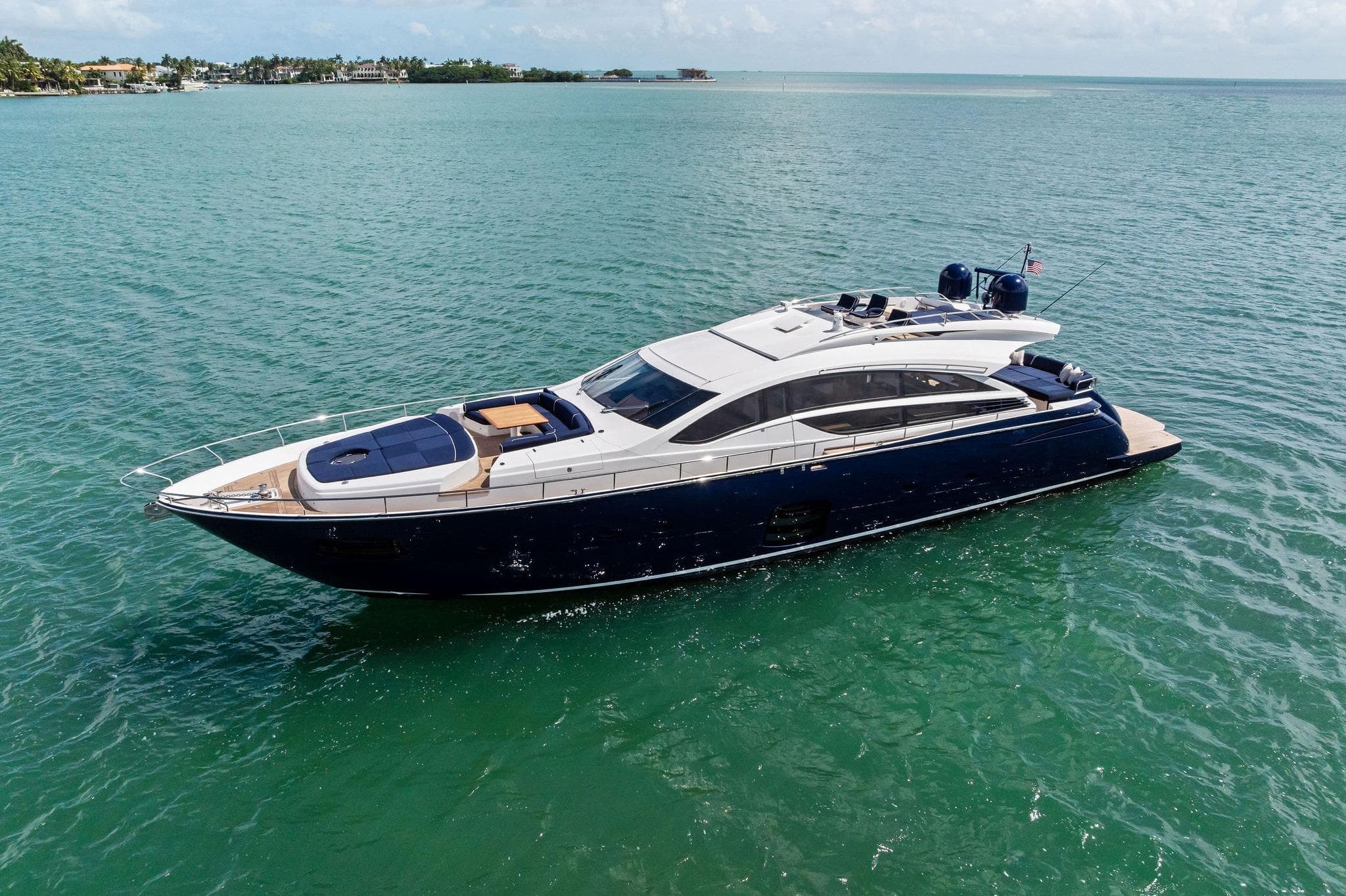 Luxurious 2013 Pershing 82 yacht cruising on clear blue waters.