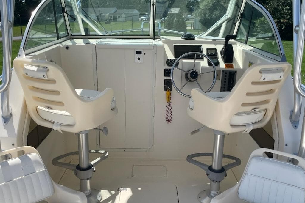 2008 Parker 2310 Walkaround boat interior with steering wheel and two seats.