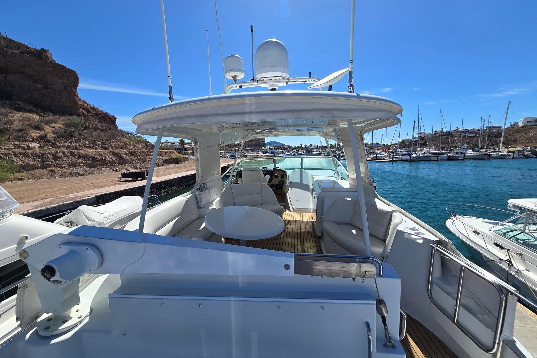 2001 Carver 570 Voyager Pilothouse yacht docked in a sunny marina setting.