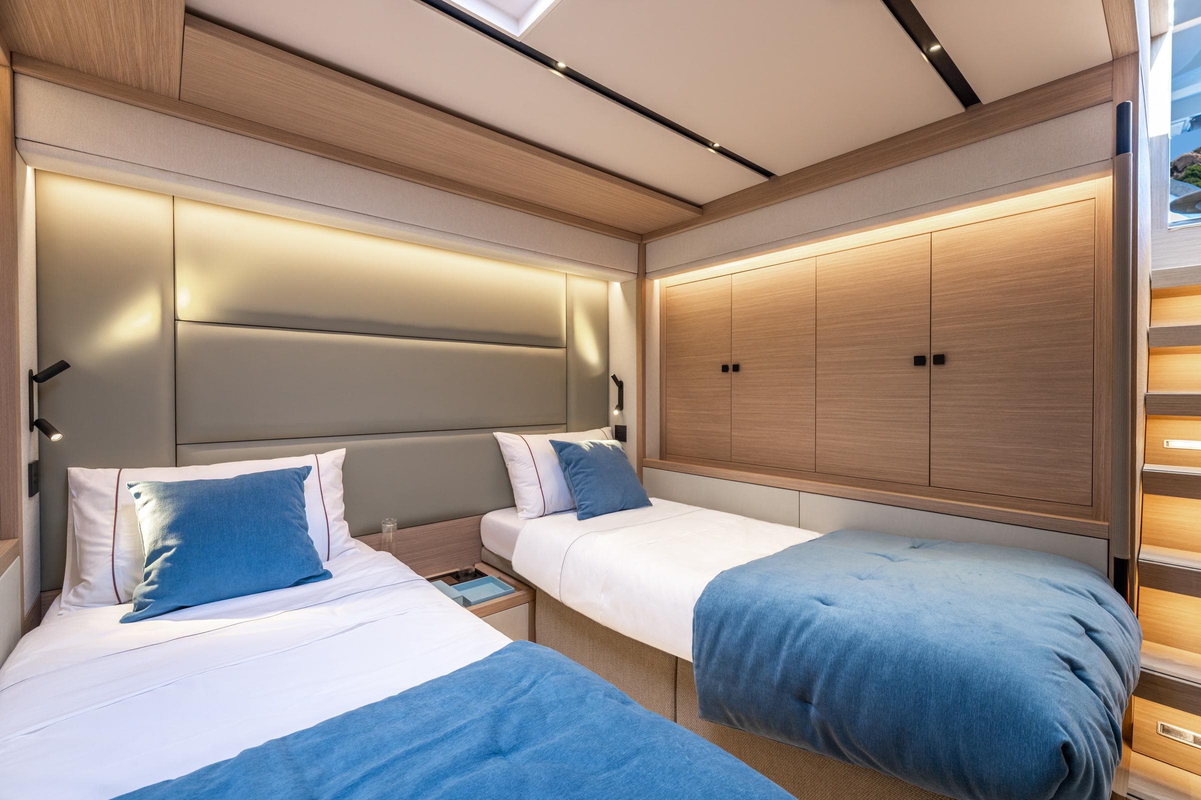 Luxurious cabin interior of 2025 Lagoon Eighty 2 yacht with twin beds and modern design.